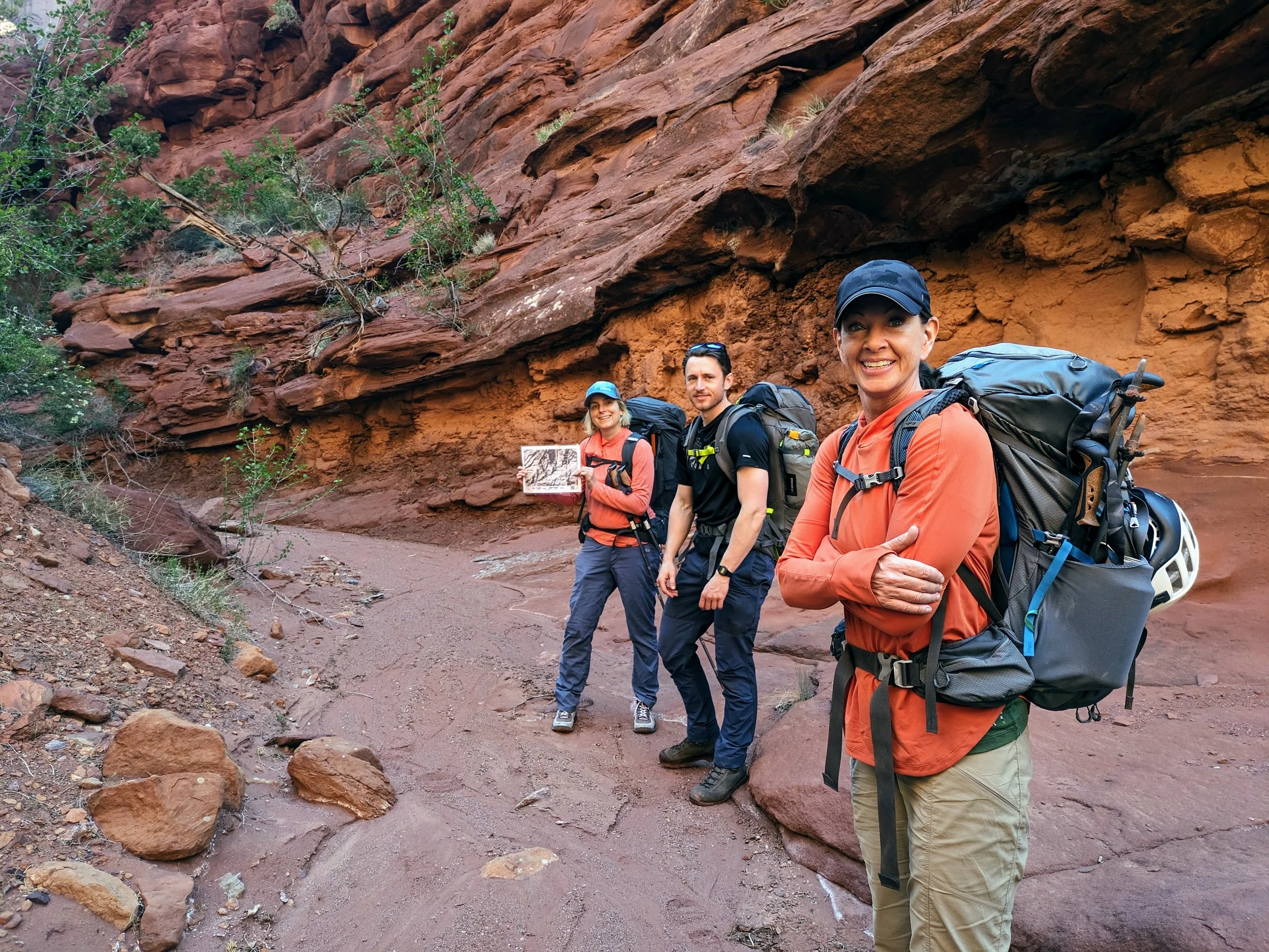 Leadership & Organizational Training in the canyons of Utah. One woman navigates while another man and woman follow