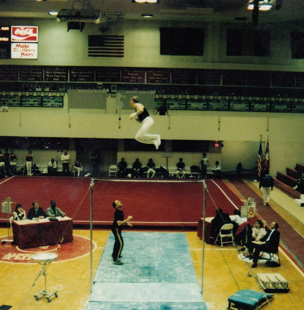 Scott Curtis competing for West Point on the men's high bar.