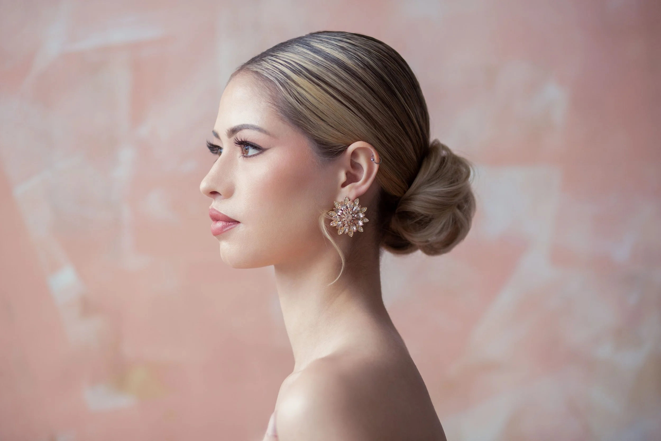 model on pink background with low up-do