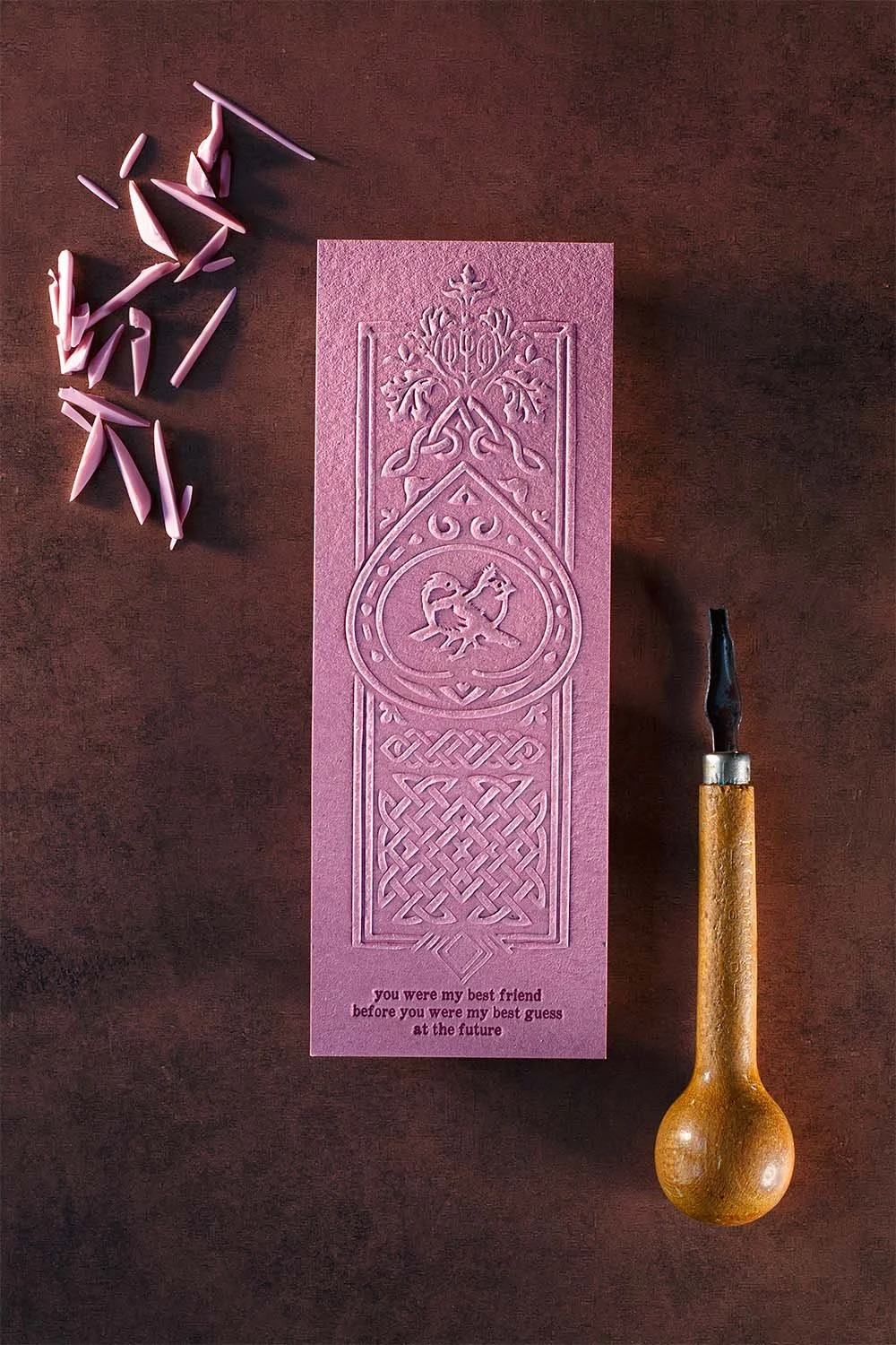 Blind embossed pink wedding bookmark with Celtic-inspired artwork and romantic quote on textured cotton paper.