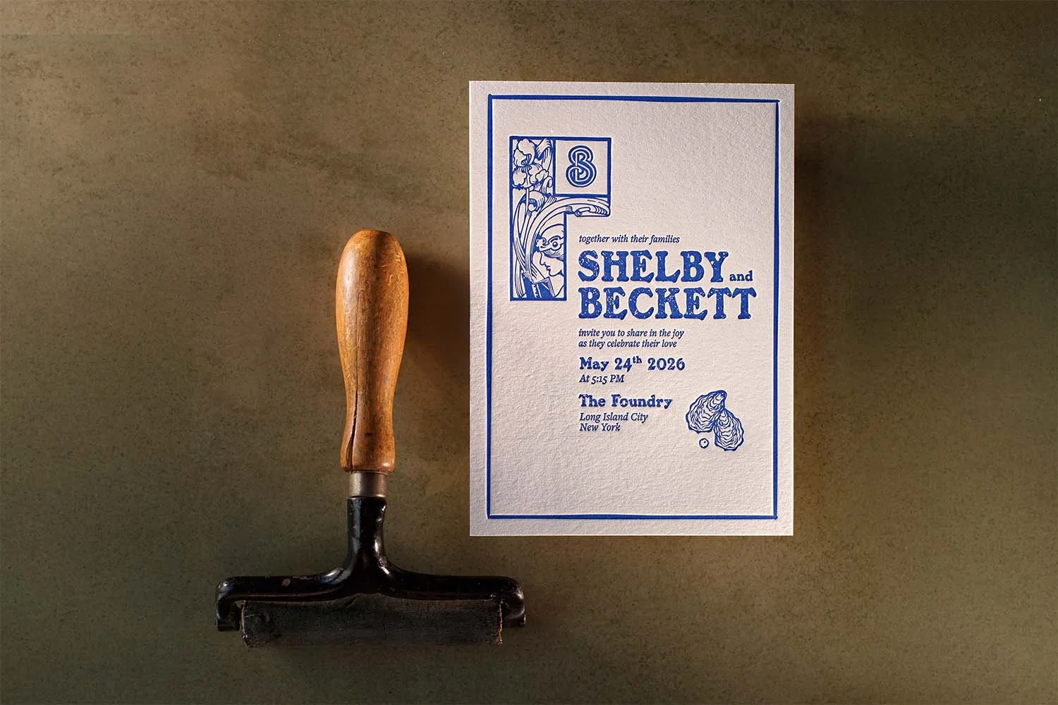 Custom letterpress wedding invitation featuring linocut-inspired artwork and deep blue ink.