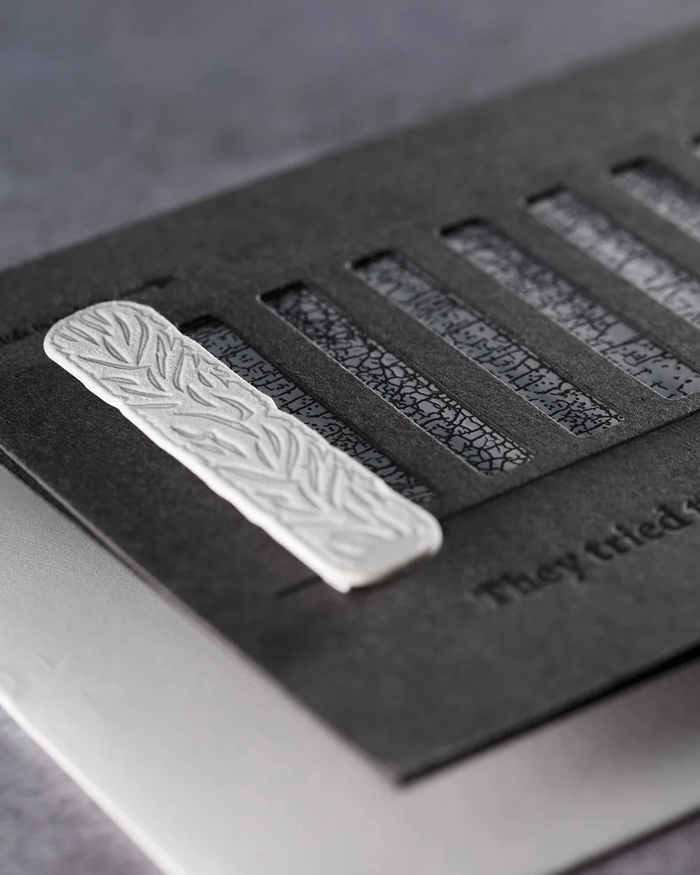 Close-up of the textured pull-tab paint roller used to reveal the Progress Pride Flag inside the card.