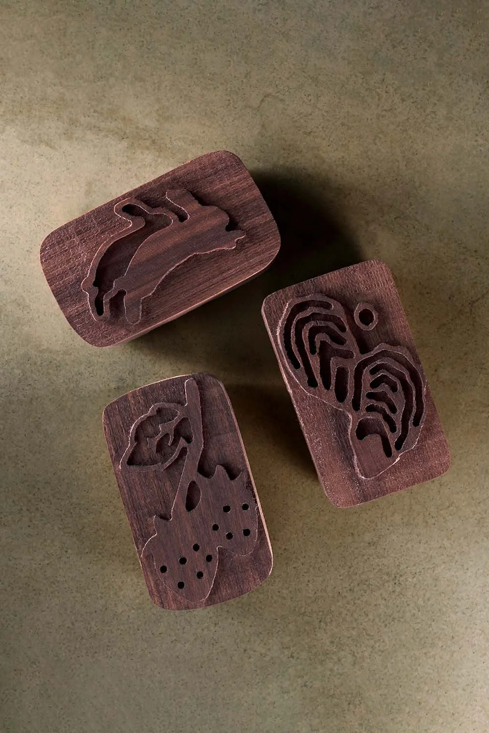 Hand-carved walnut wedding escort card blocks featuring custom rabbit, oyster, and botanical illustrations inspired by a couple’s story and wedding details.