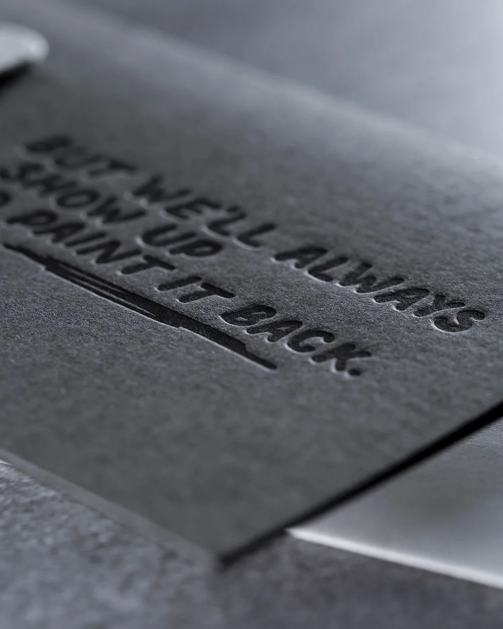 Letterpress detail of the “But We’ll Always Show Up to Paint It Back” message on the Pride Ally Card.