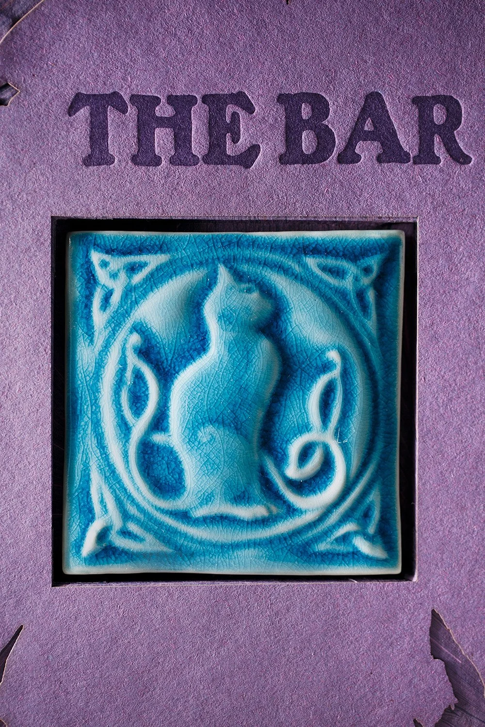 Handmade blue ceramic tile inset featured in a custom wedding bar sign, showcasing artisan glazing, texture, and decorative wedding signage details.