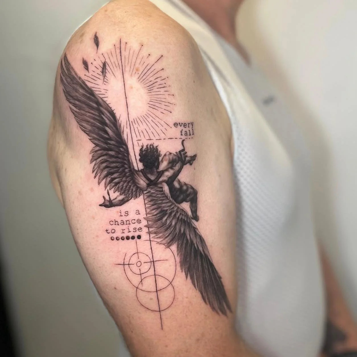 Fine line fine detailed microrealism style upper arm tattoo featuring the Fall of Icarus, with geometry surrounding, the phases of the moon, and typewriter font reading 'every fall is a chance to rise'.