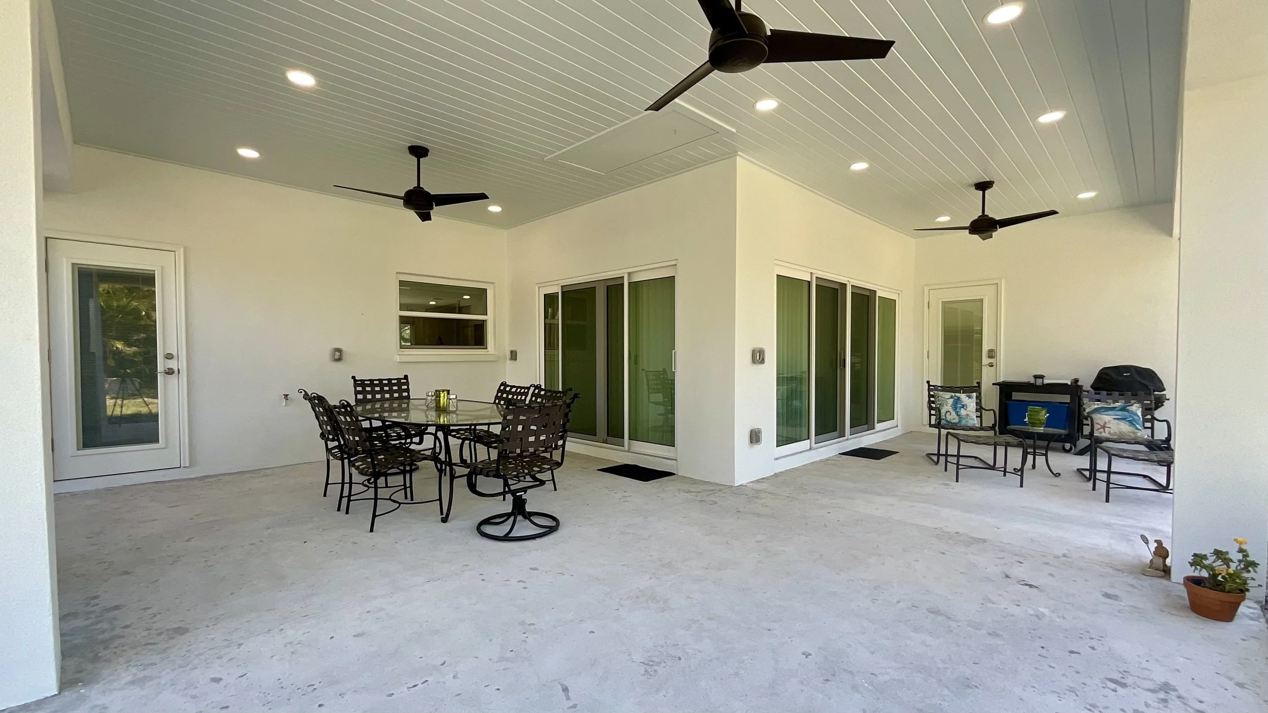Lanai addition with 10-foot ceiling, unfinished concrete floor, ceiling fans, recessed lighting, and access to dining room, pool bath, and master bedroom.