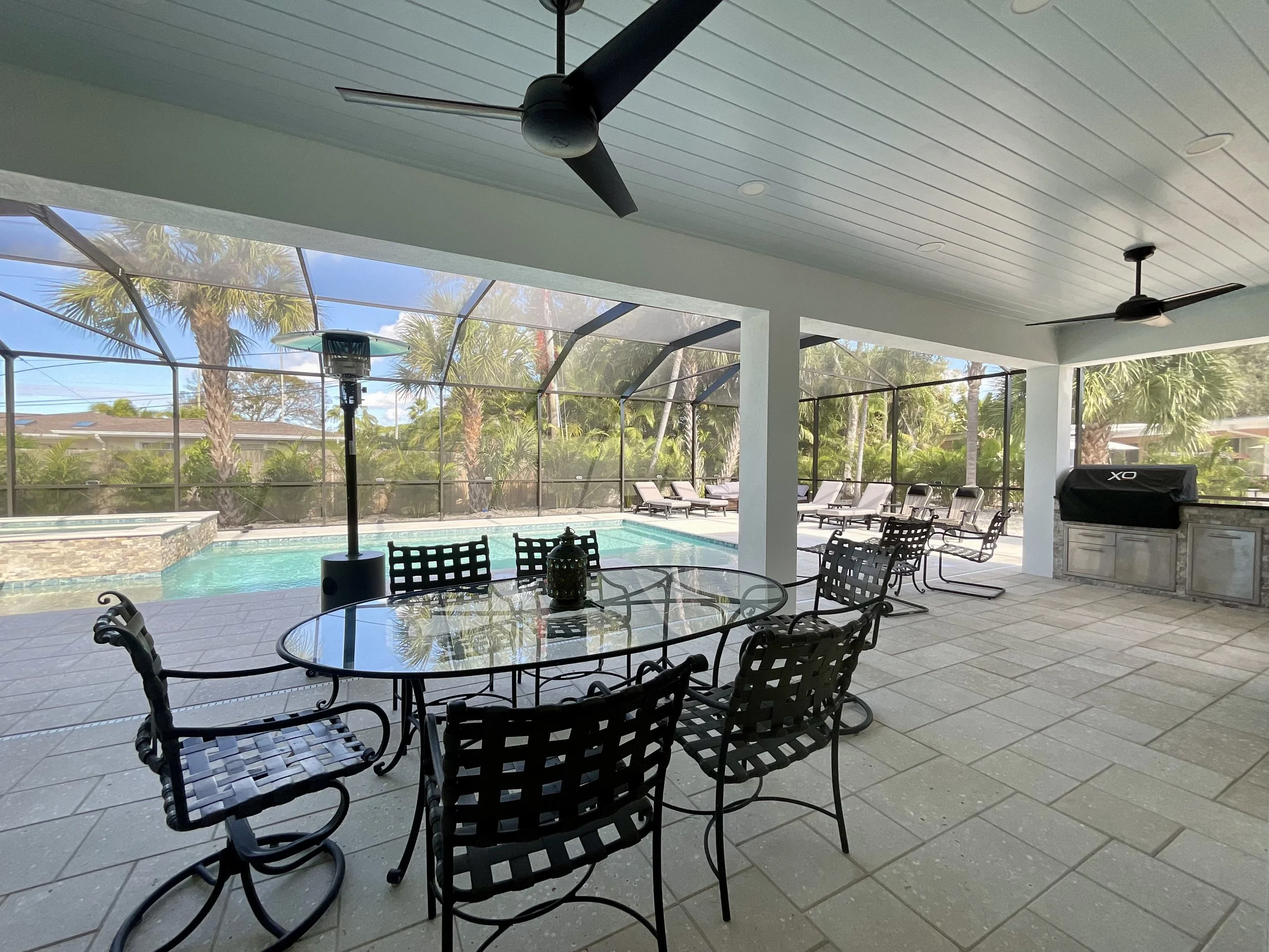 Lanai addition with 10-foot ceiling, unfinished concrete floor, ceiling fans, recessed lighting, and access to dining room, pool bath, and master bedroom.
