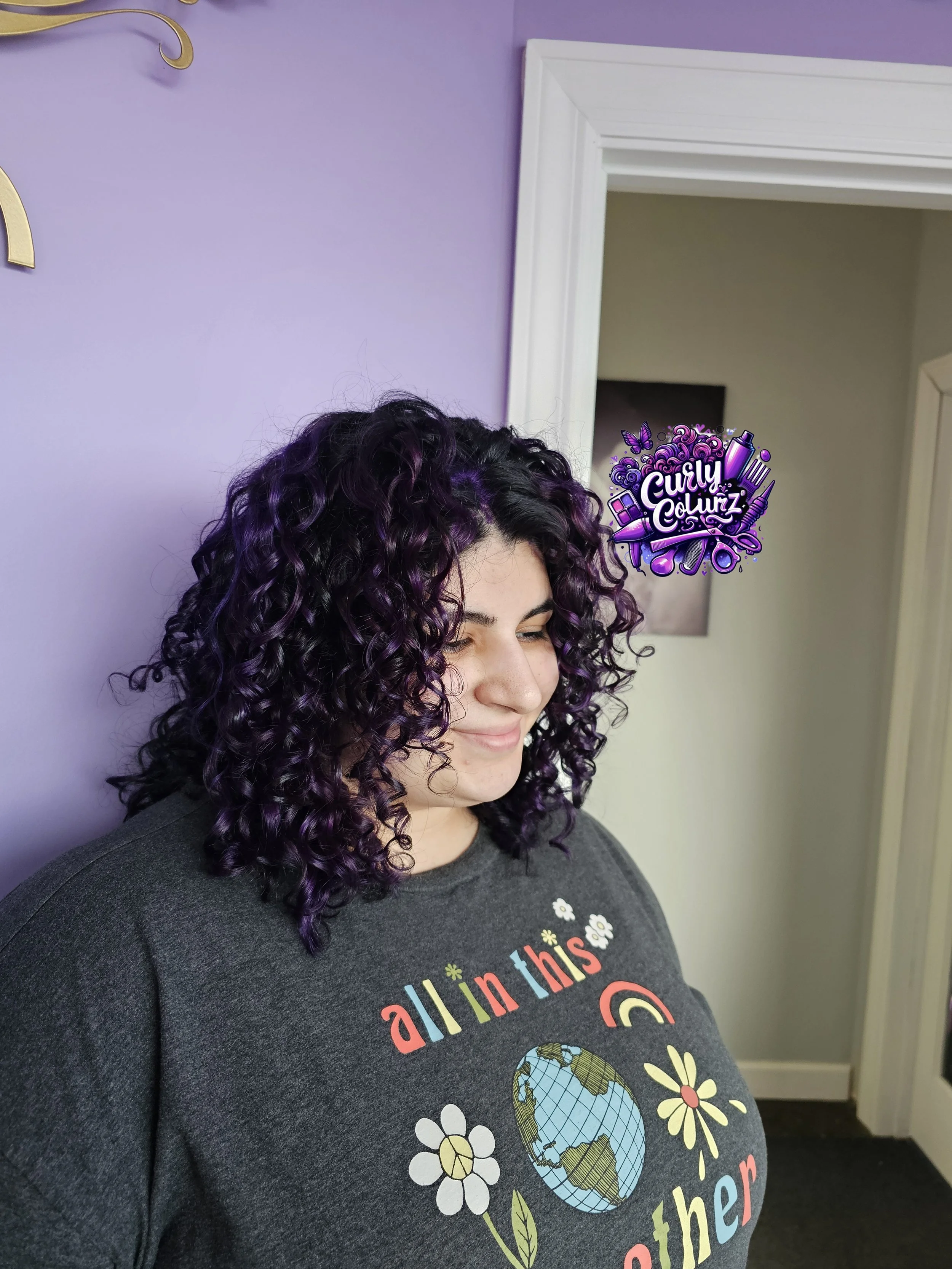 Back view of custom dark purple curly hair color at Curly Colurz salon in Crystal Lake