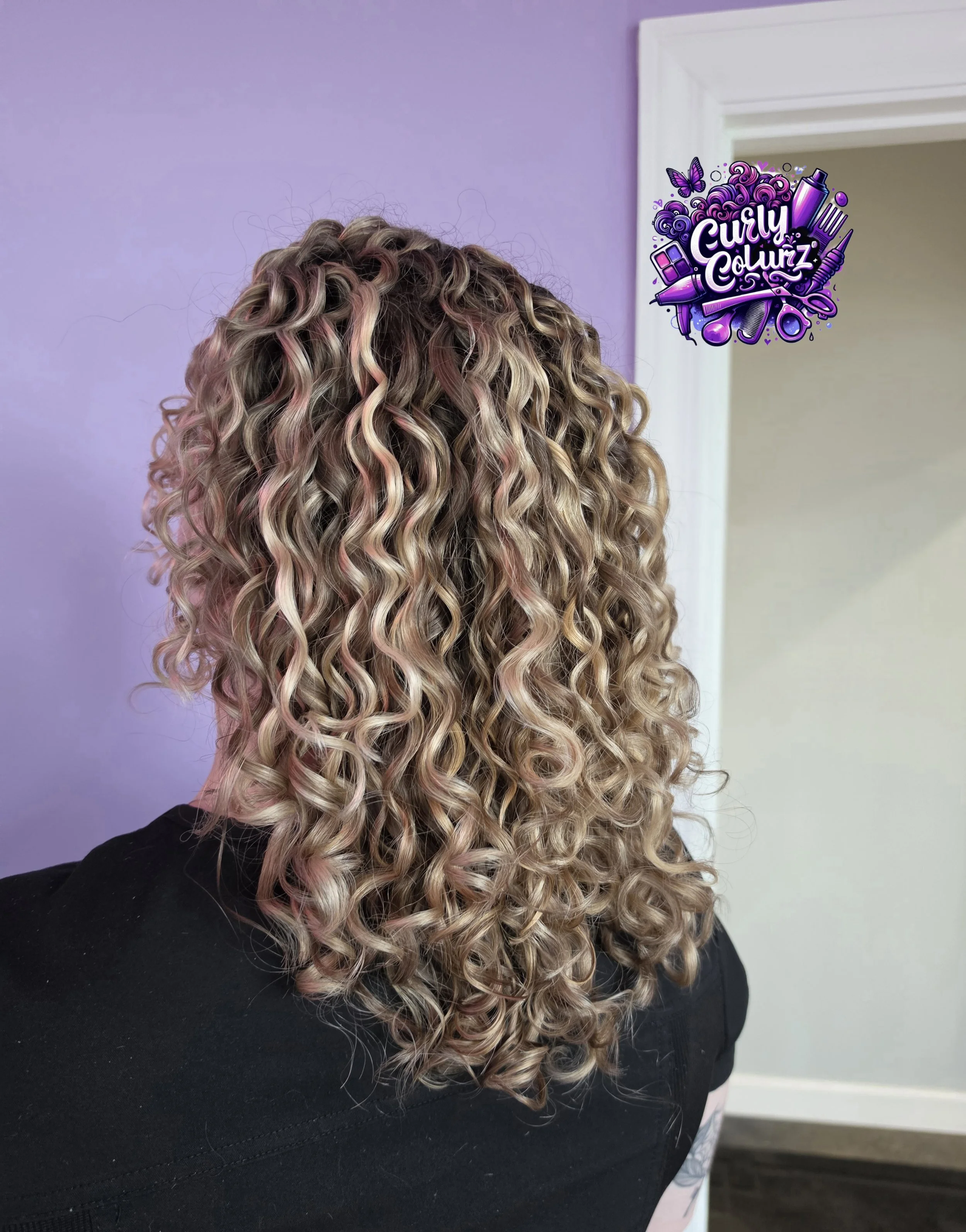 Curly hair balayage with blended dimension shown from the back at Curly Colurz