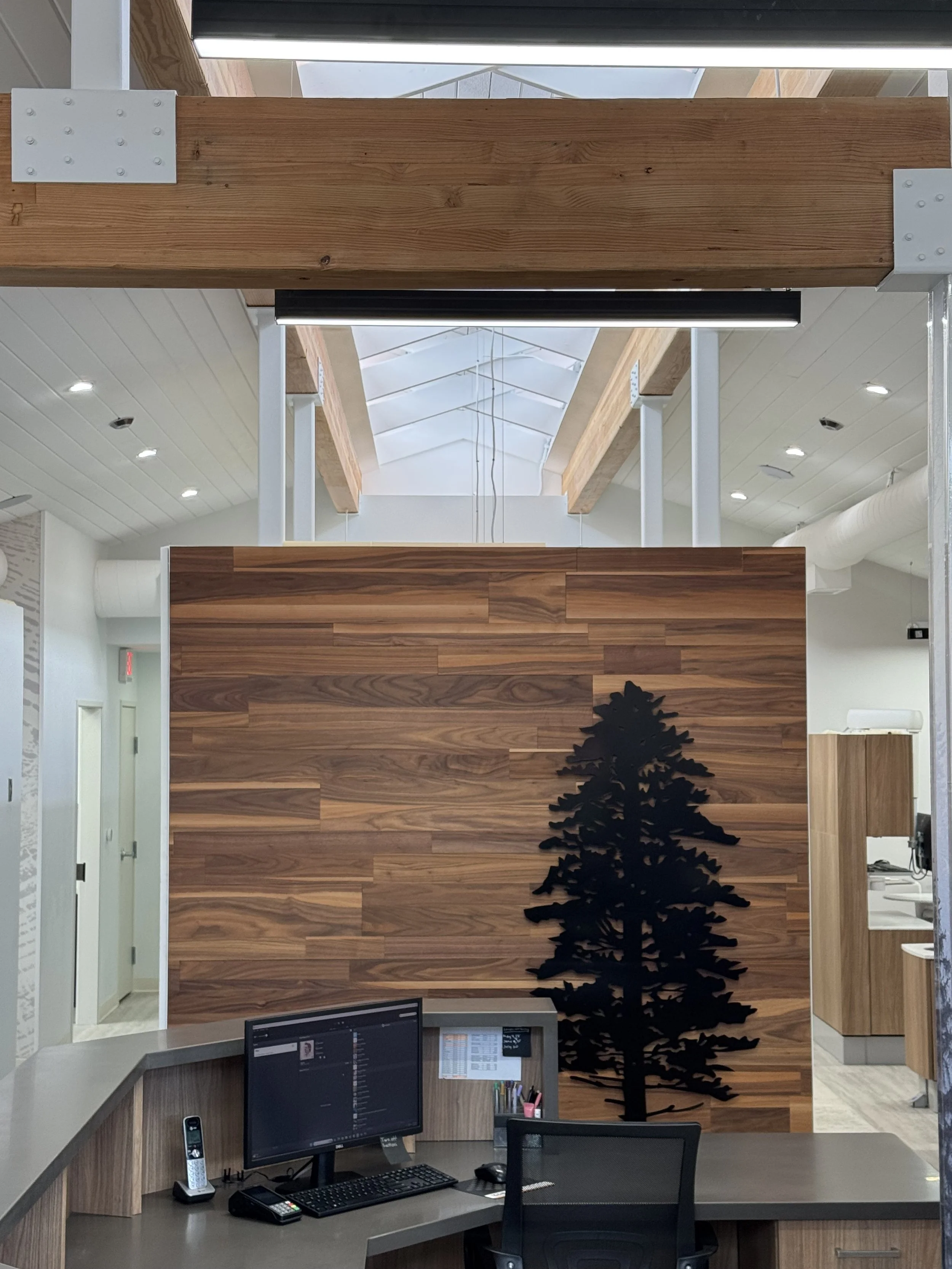 Another view of the giant beams we installed and the wood wall treatment made from wood salvaged from the old office.