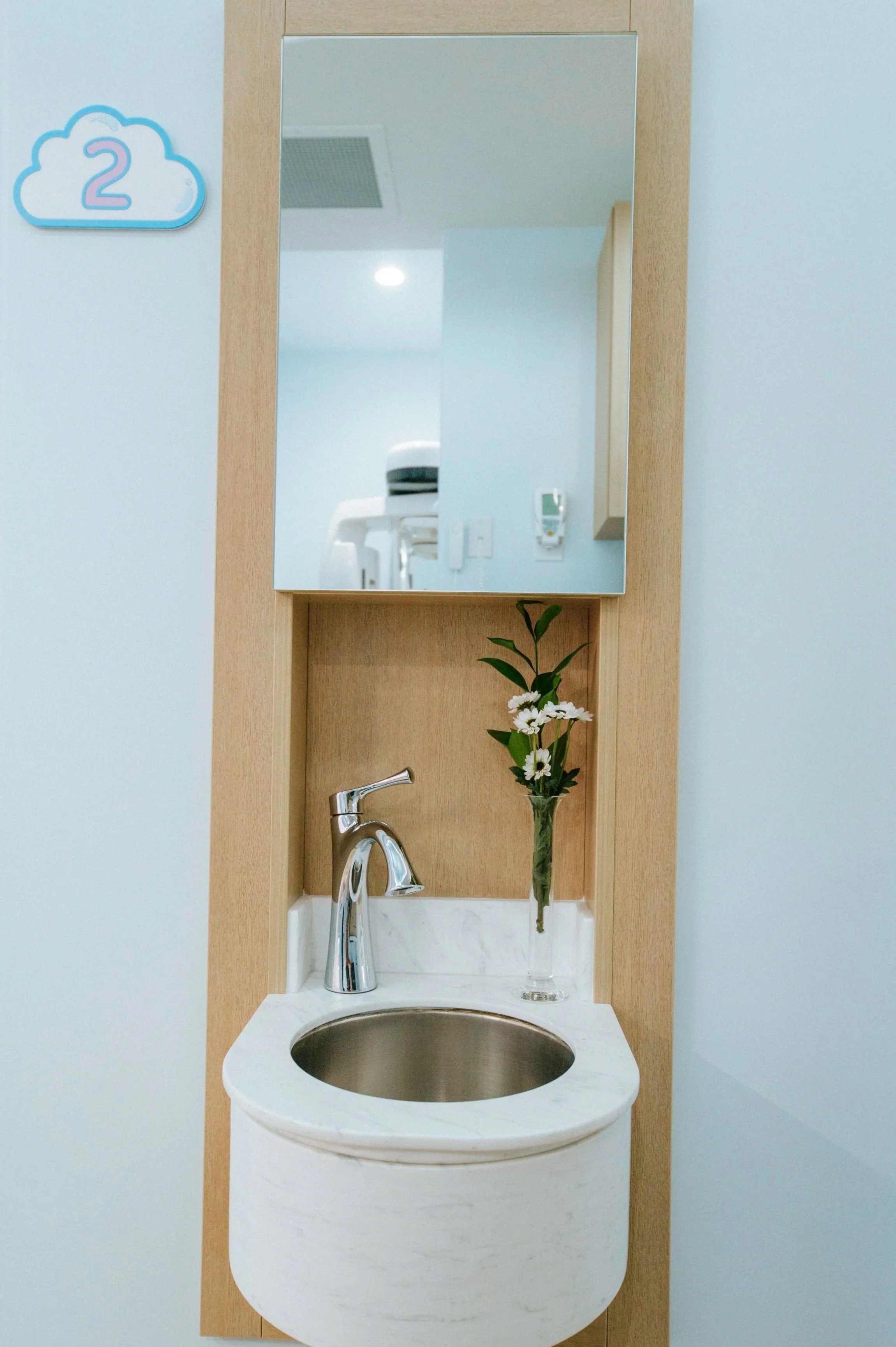 Sinks are set into the walls for handwashing.
Custom made acrylic room number signs by Harper Studios complete help with wayfinding.