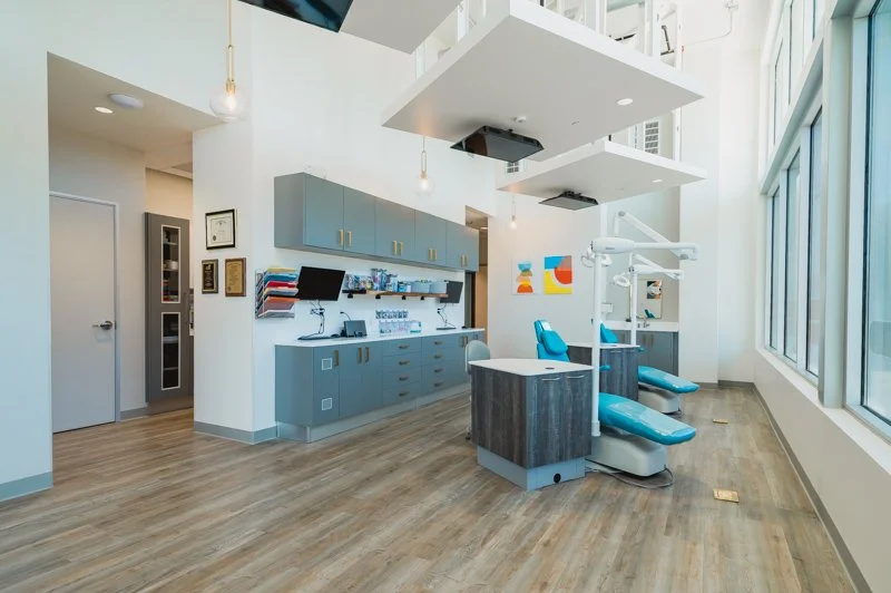 blue wall dropped ceiling dental office pediatric dentistry open bay Boyd benches t.v.'s on ceiling