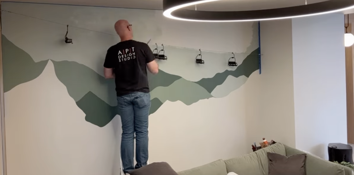 Martin painitng a mountainscape in our Milhaus project!