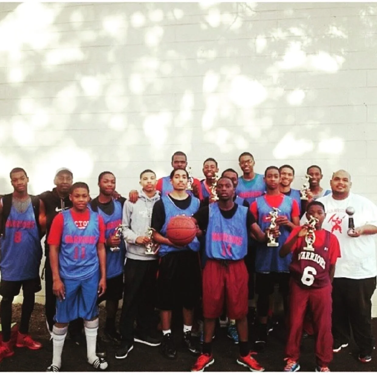 Youth wearing basketball gear, colors black, 
red and blue. 