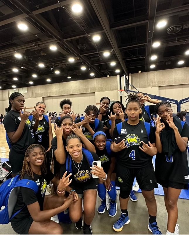 YOUTH WEARING BLACK YELLOW AND BLUE, AS THEY POSE FOR THE PICTURE.