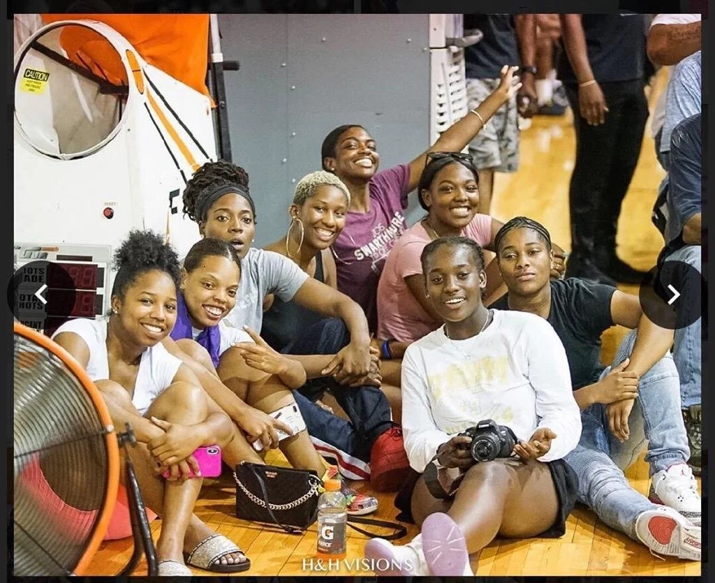 Female youth part of the Youth Development program sitting on the floor. 