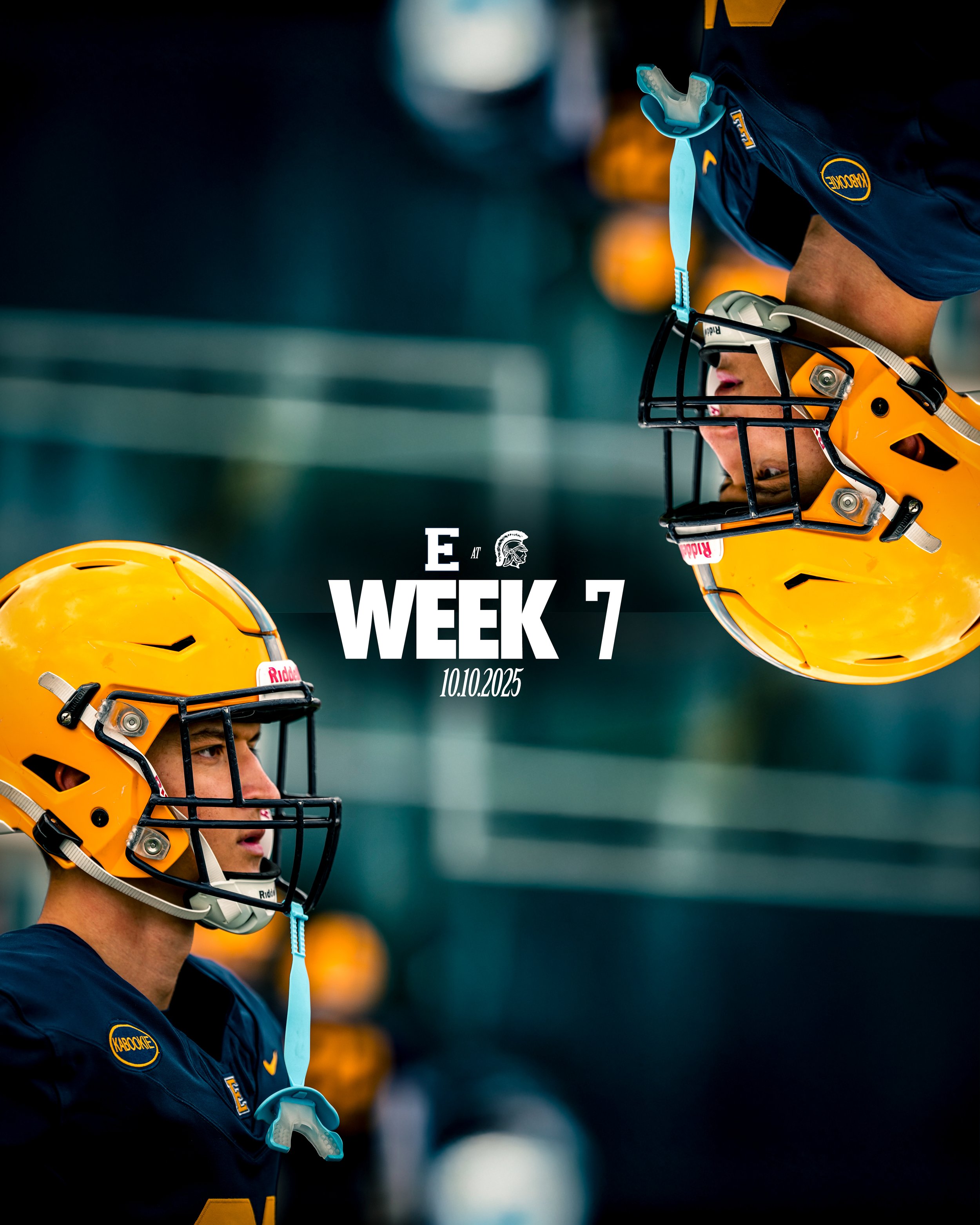 Two football players wearing yellow helmets and navy uniforms are facing each other head-to-head on the field during a game.