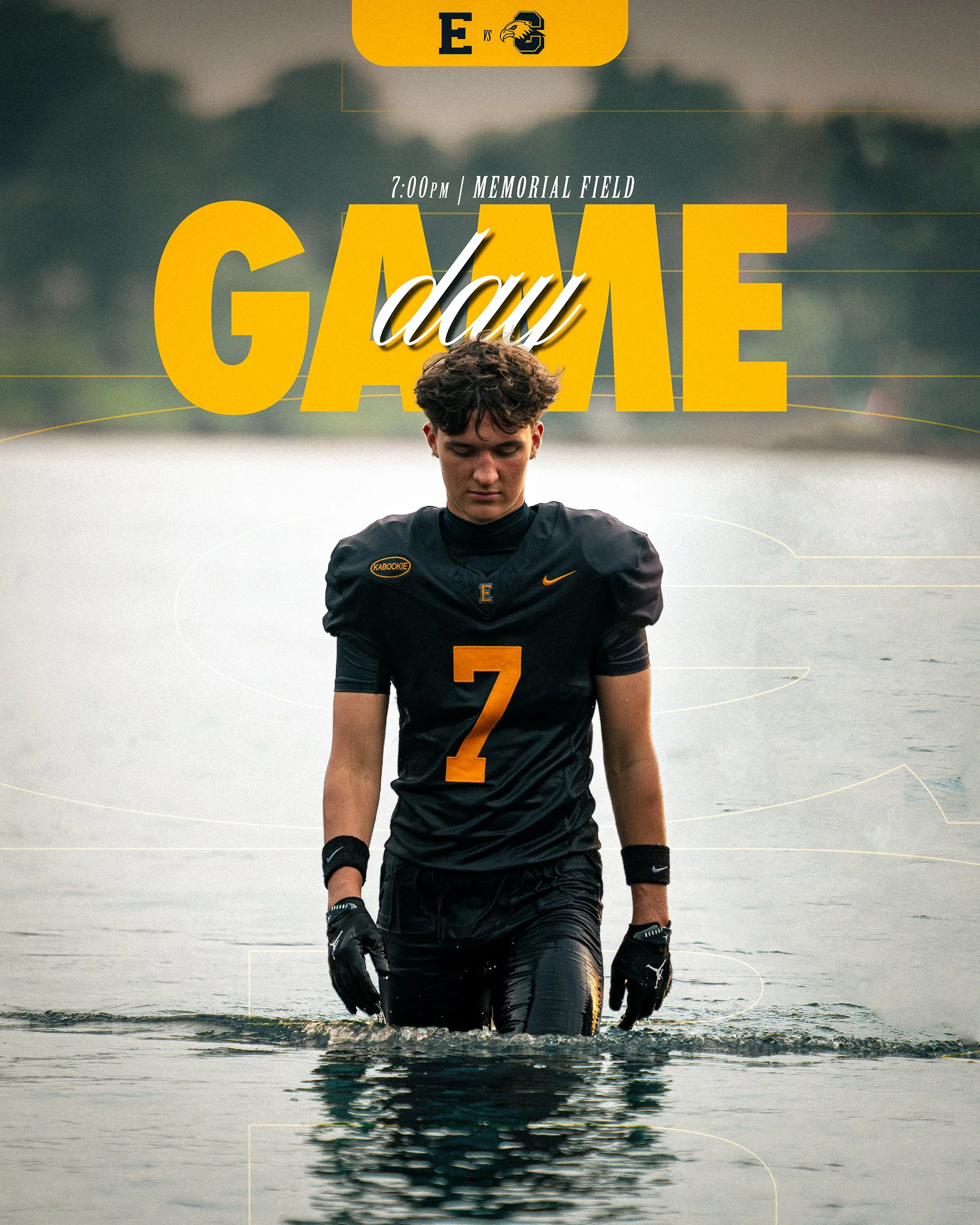 A young male athlete wearing a black sports uniform with a yellow number 2, standing in shallow water with a serious expression. The background shows a body of water and a cloudy sky. Text overlay indicates an event at 7:00 PM on Memorial Field with 
