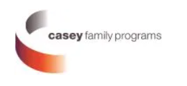 The logo for Casey Family Programs, showing a stylized, open-circle dimensional ribbon that fades from purple and red to orange and gray on the left, placed next to the horizontal text "casey family programs."