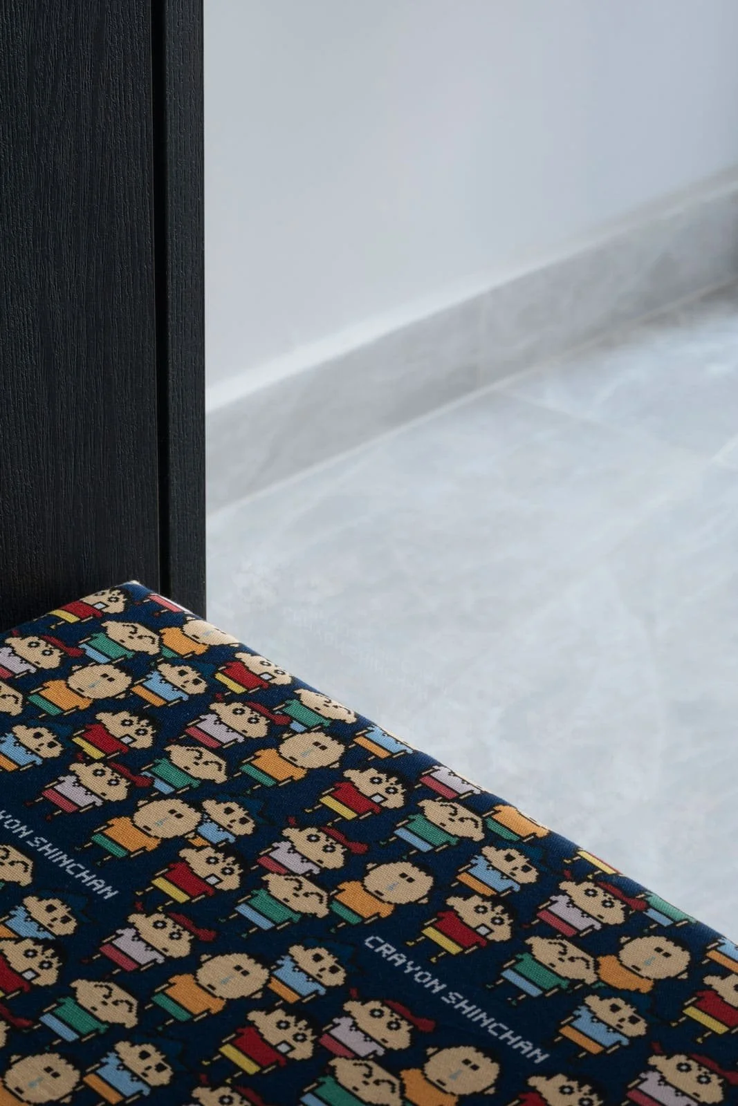 Close-up detail of patterned bench cushion in a modern Singapore condominium entryway.