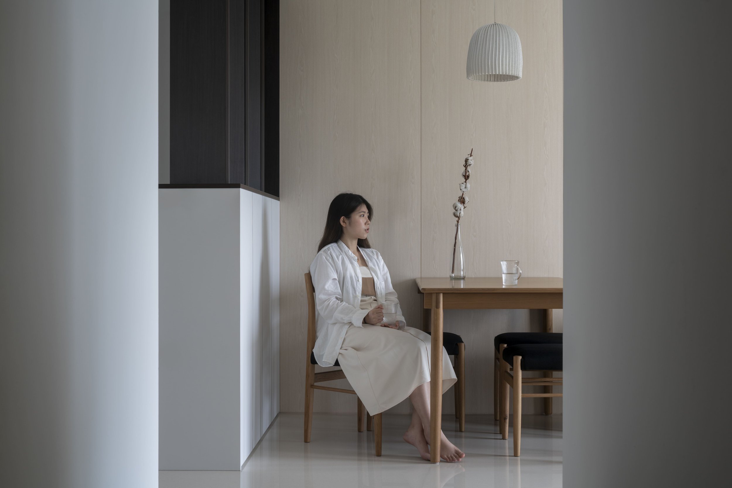 Minimalist Singapore dining area with light-wood furniture and soft neutral interiors.