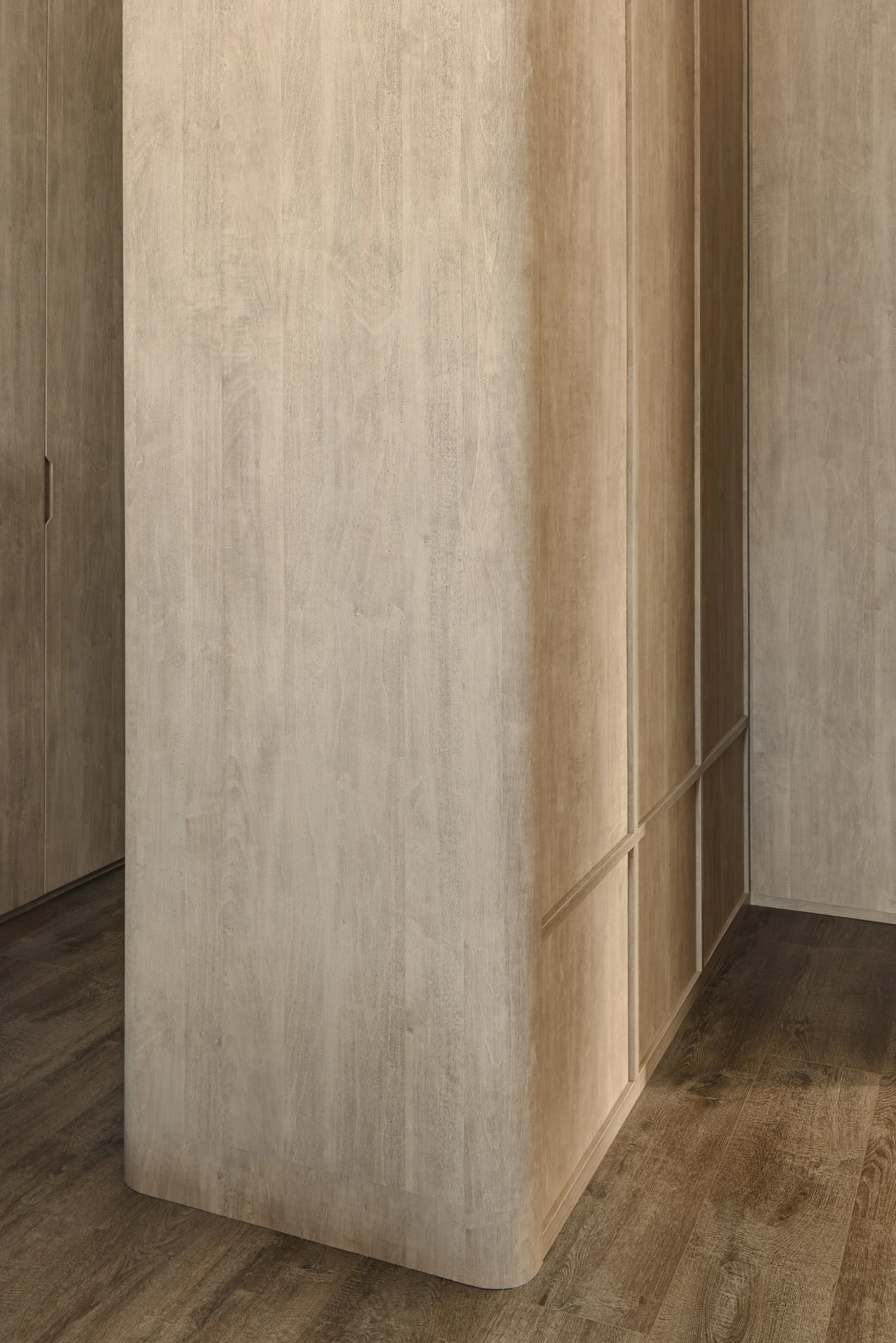 Minimalist wood cabinetry with rounded column and seamless panel detailing.