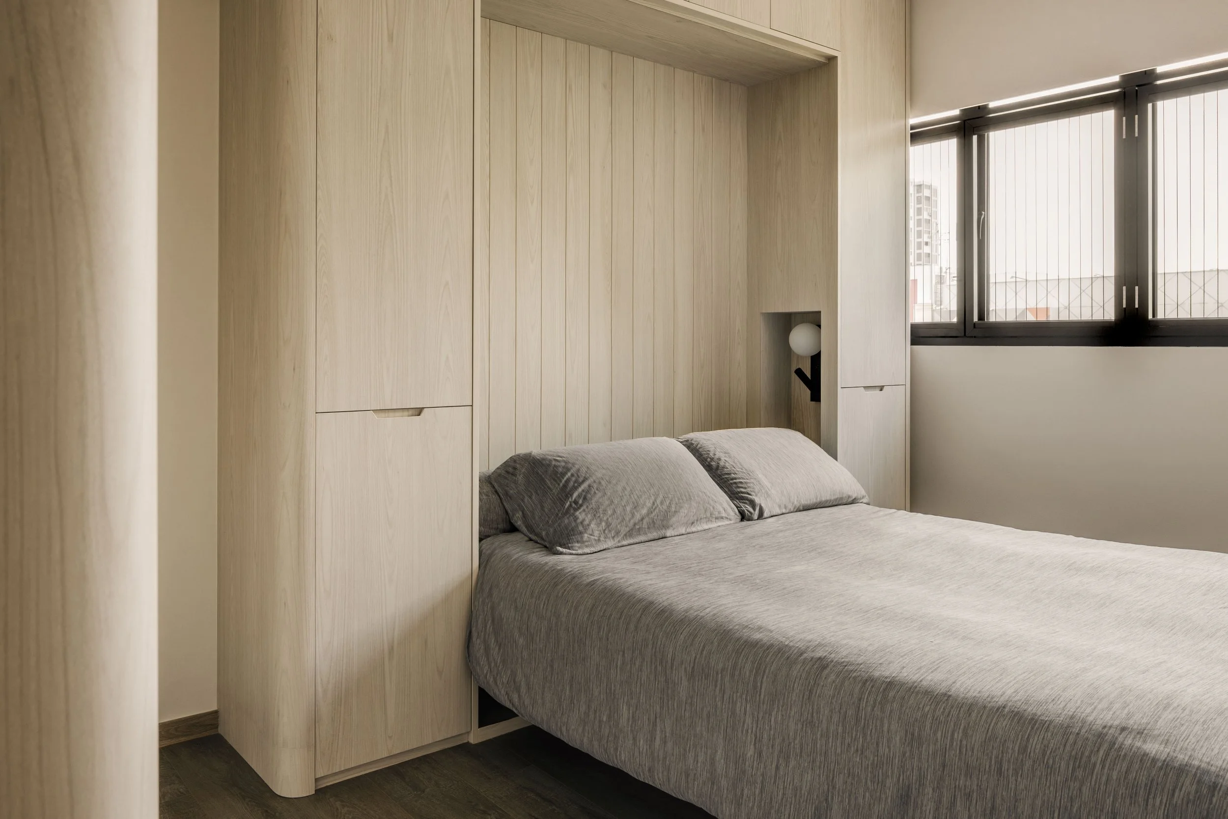 Modern minimalist bedroom with built-in murphy bed.
