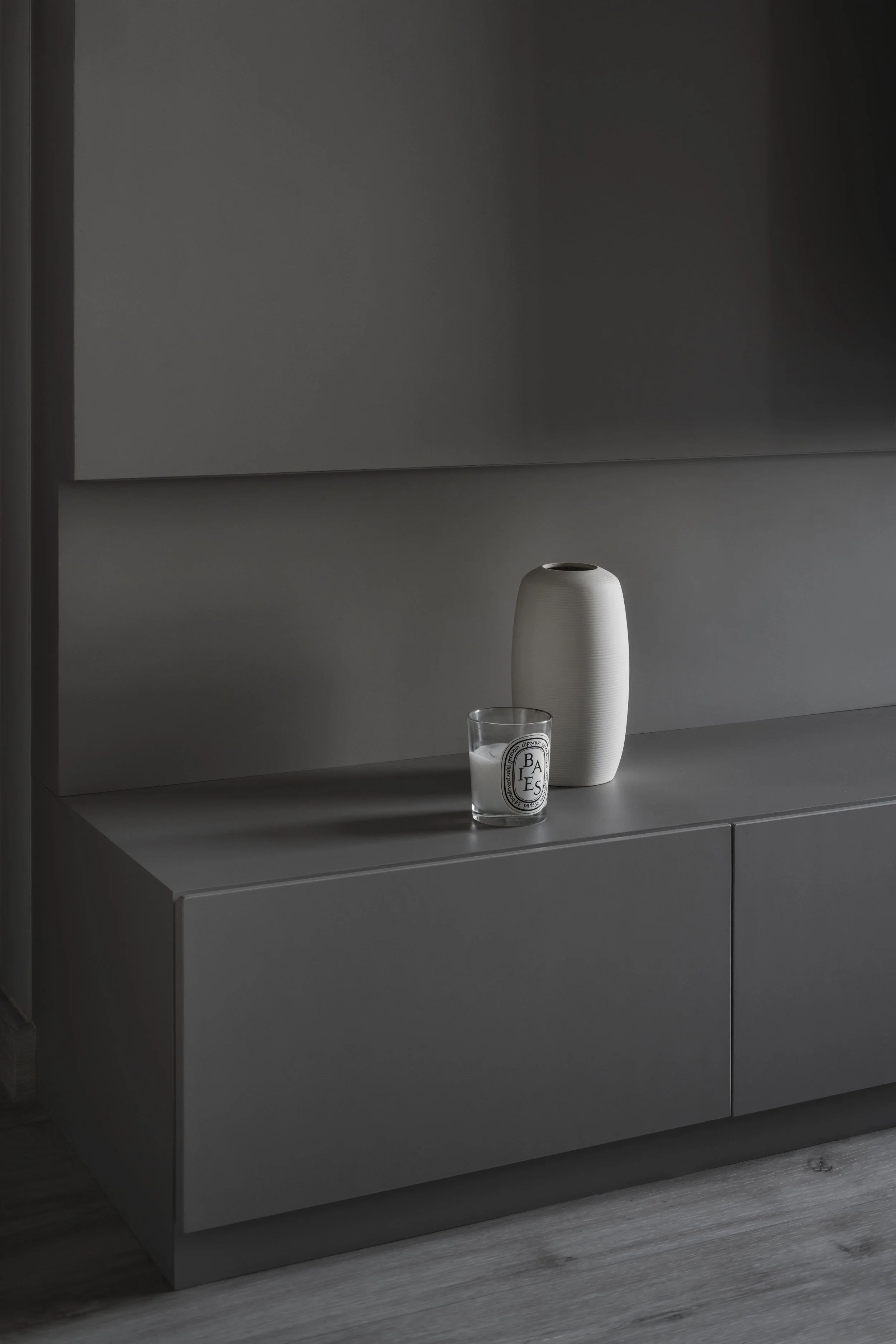 Minimalist matte grey low cabinet with styled décor.