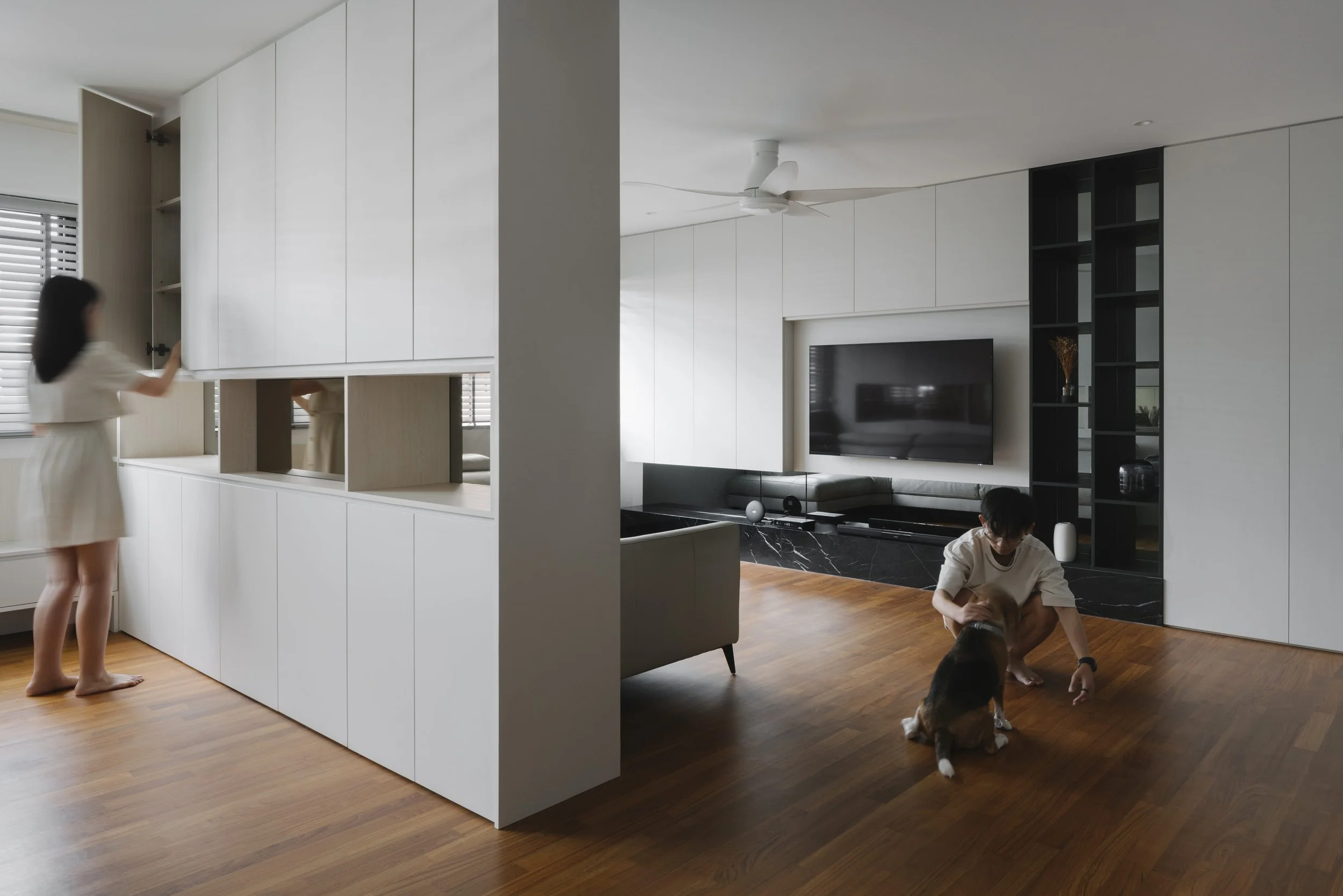 Modern Singapore home with custom built-in cabinetry, open living space and a family dog, designed by Lite Design Collaborative.