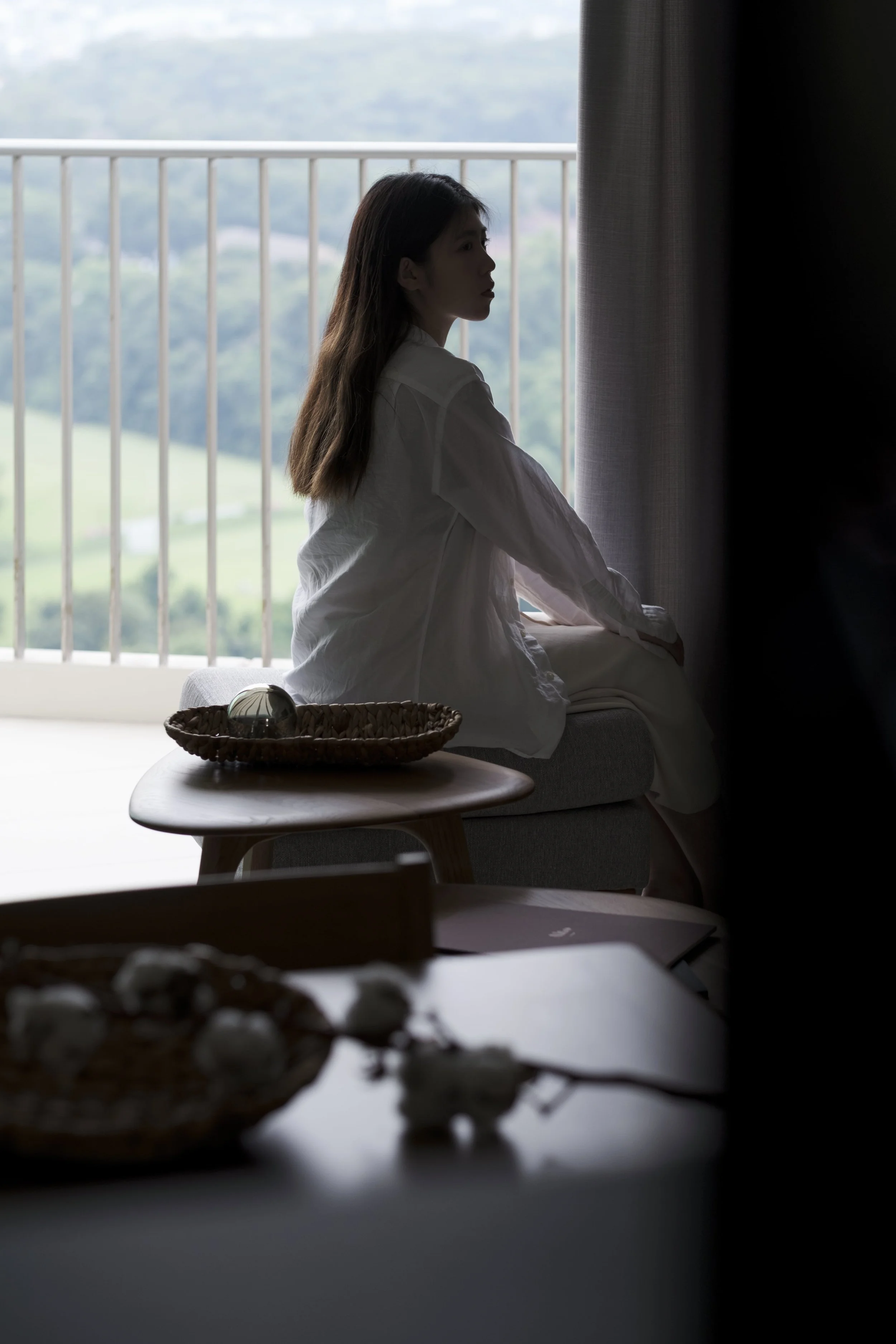 Singapore condo living space with relaxing balcony view and minimalist furniture.