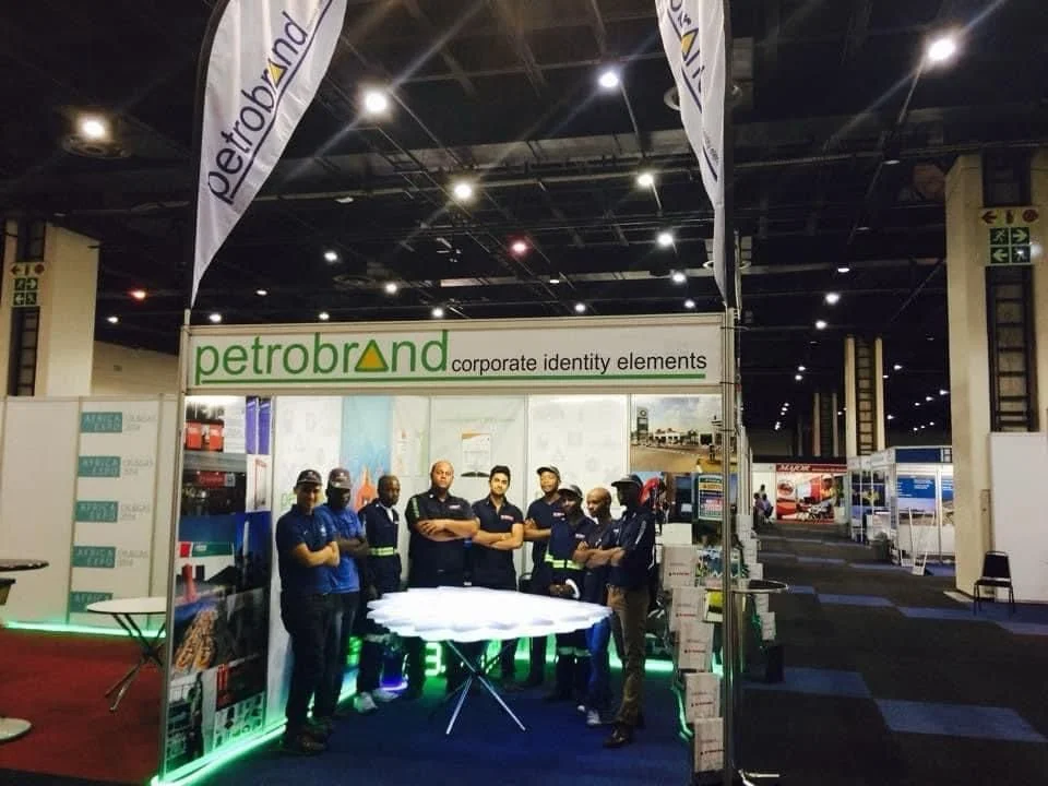 Trade show booth with Petrobrand signage and standing people