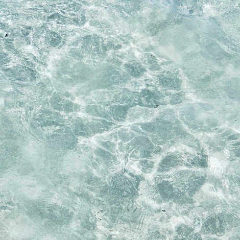 Close-up of water with gentle ripples and light reflections.