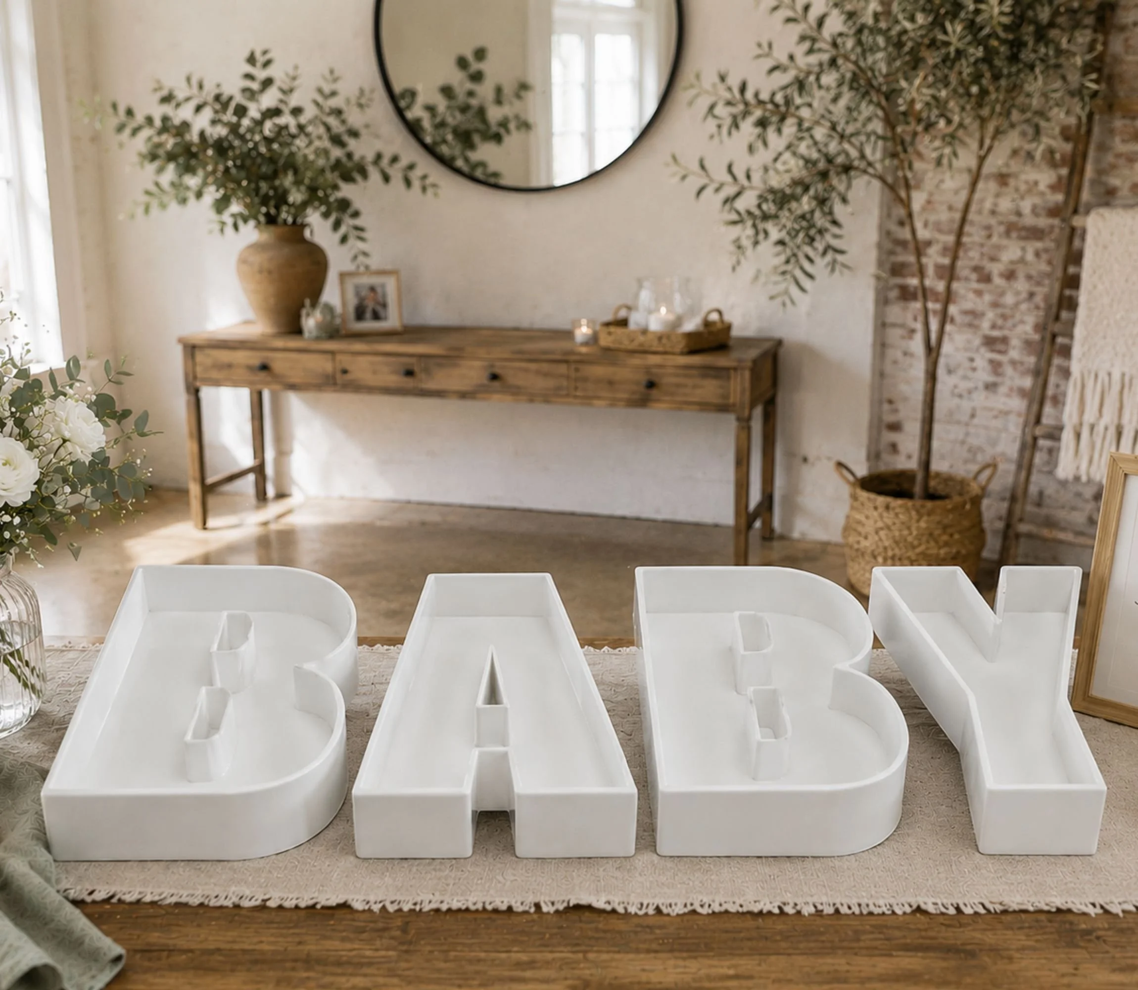 Baby letters on a table with timber coffee table in the background