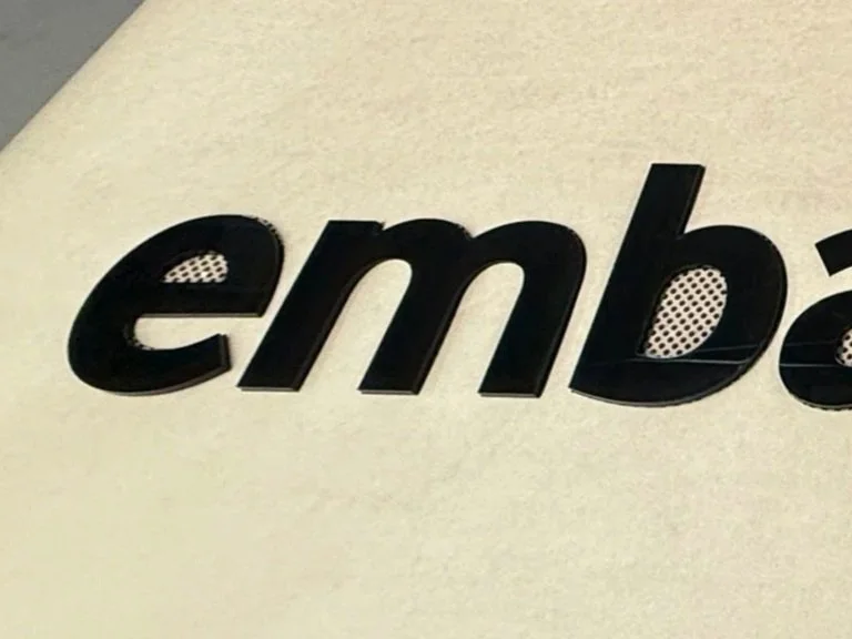 Black acrylic logo in a paper template