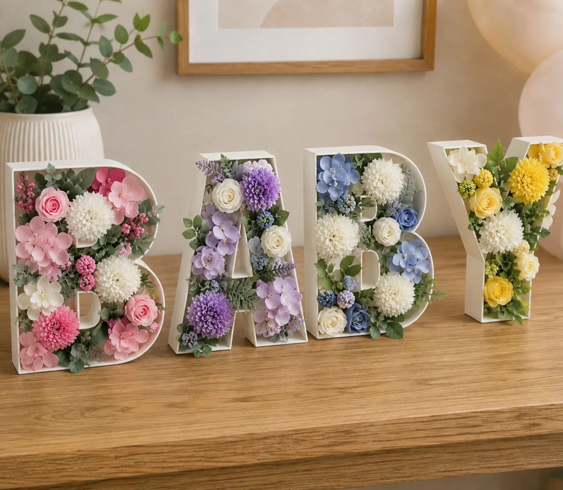 Flowers inside the word baby , yellow, white, blue, pink and more fo decorations for a baby shower