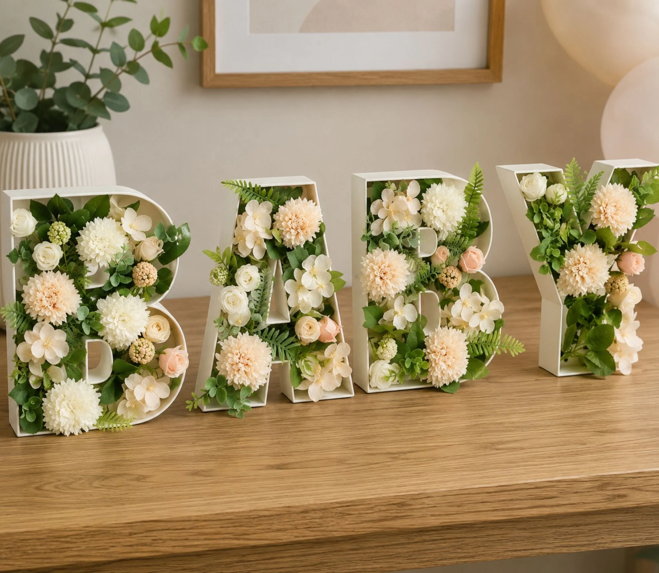 Baby letters full of floral decor sitting on a laminated wooden table