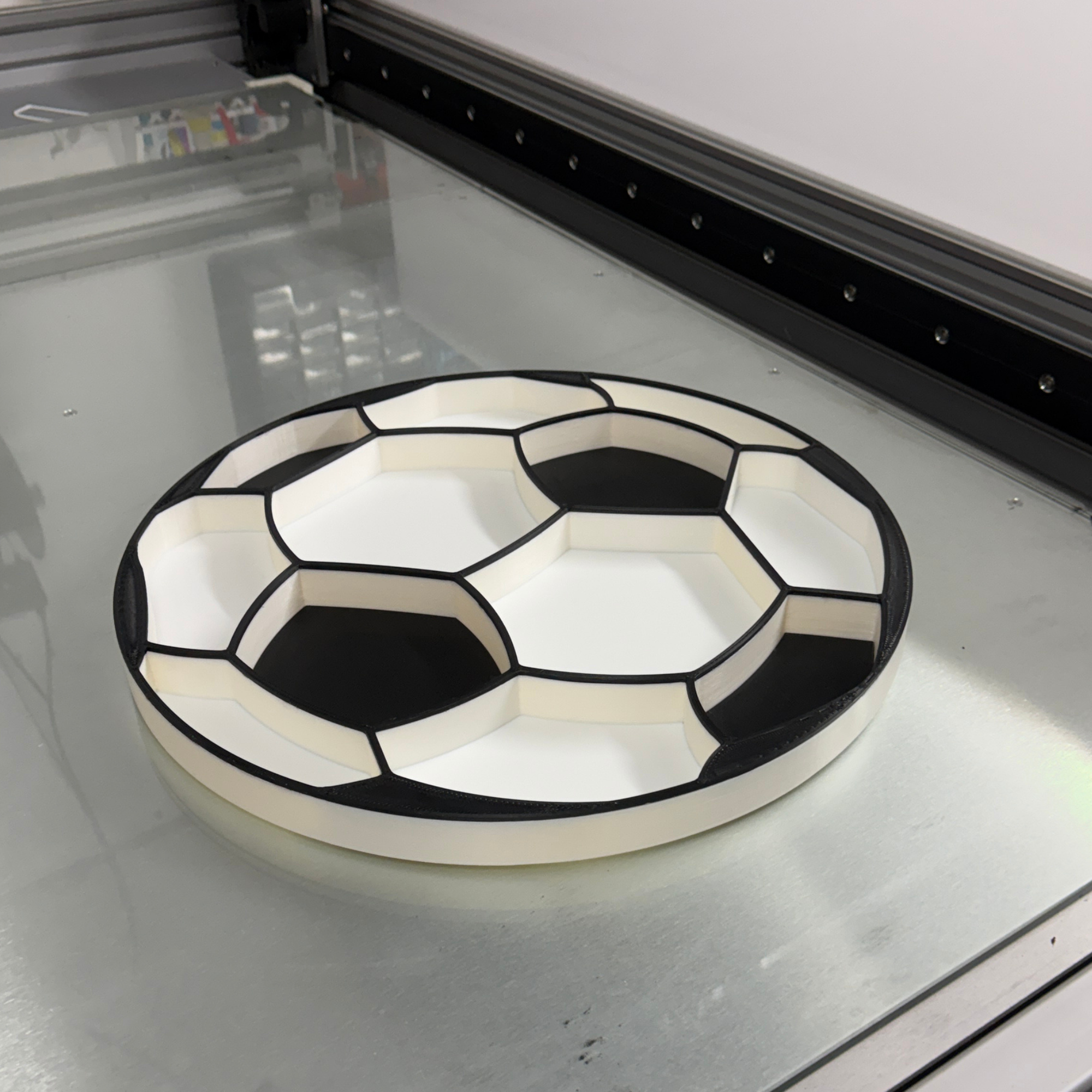 Black and white plastic serving tray on a glass bench