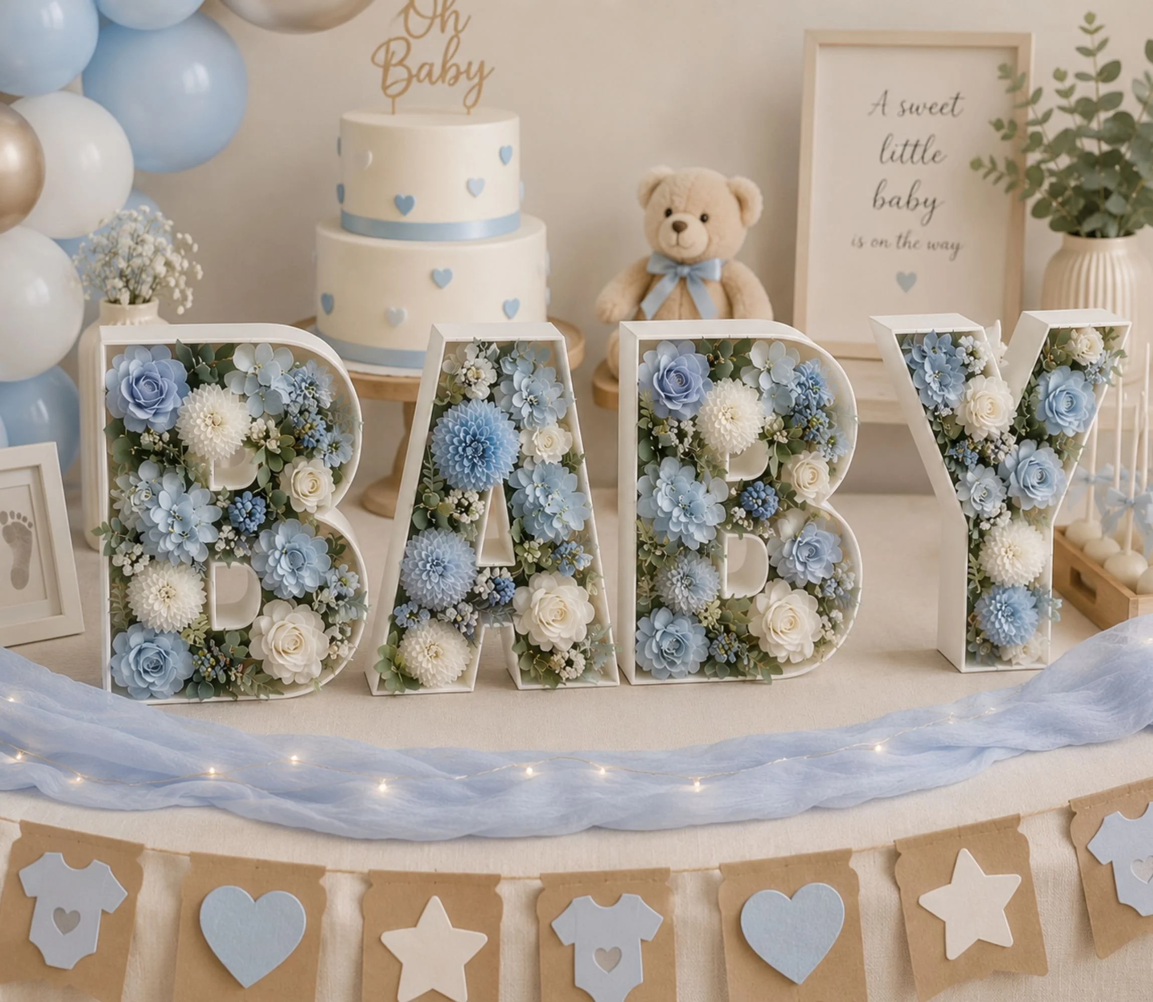 White baby letters full of blue and white rosses with decoration in the background