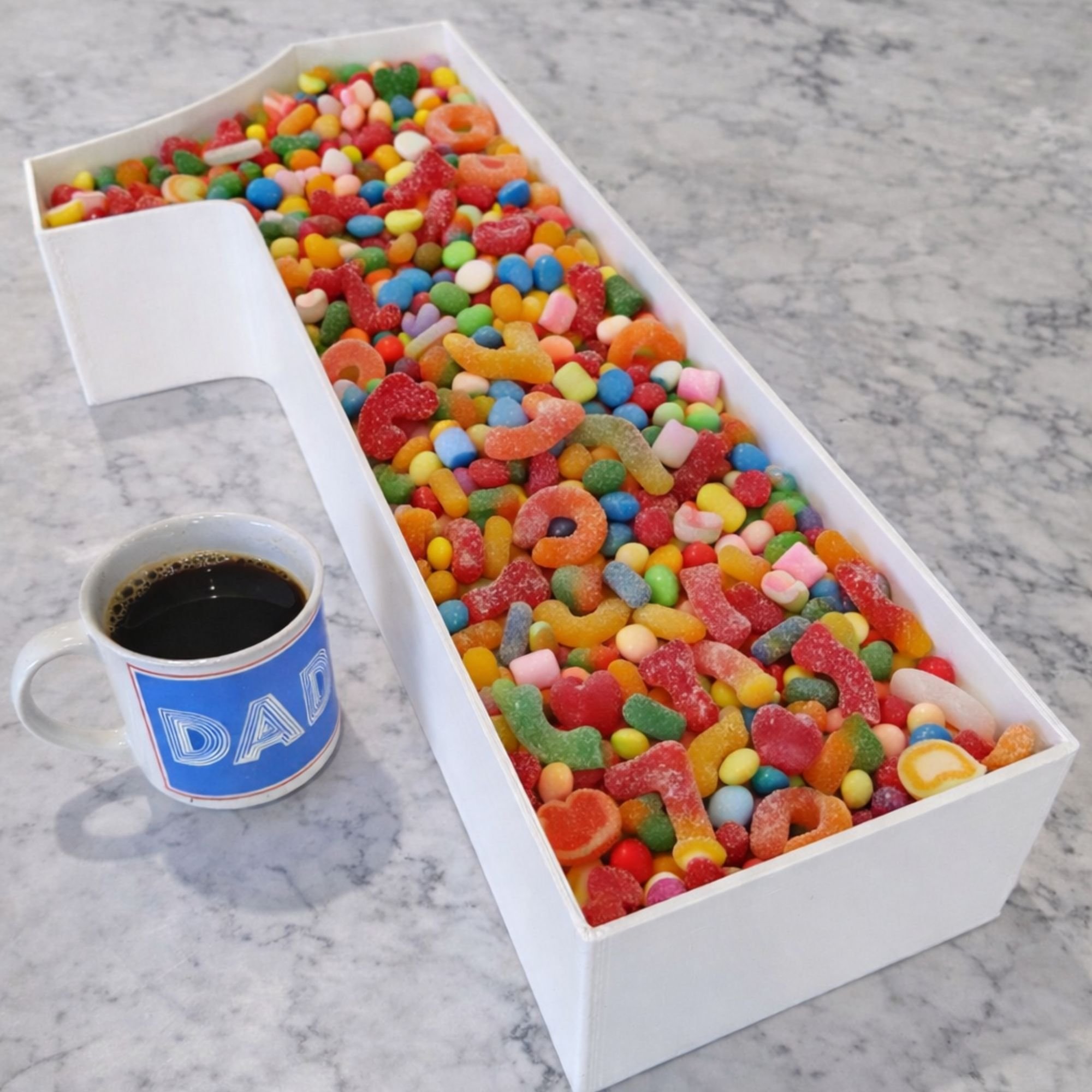 white number 1 charcuterie tray filled with colourful lollies