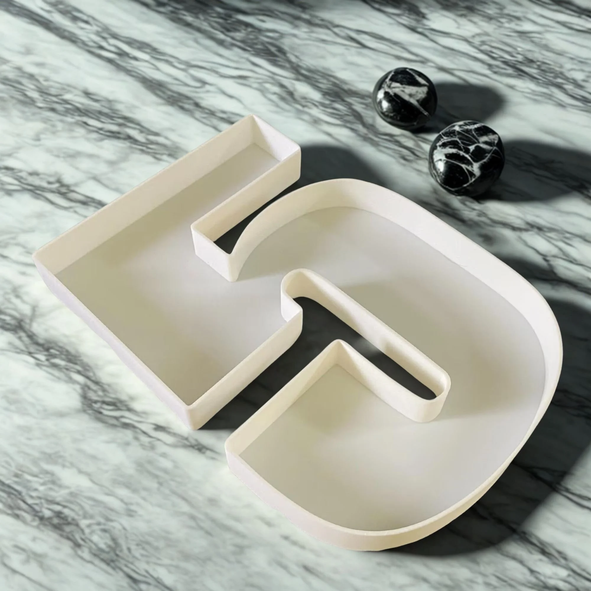 White plastic number 5 on a marble table