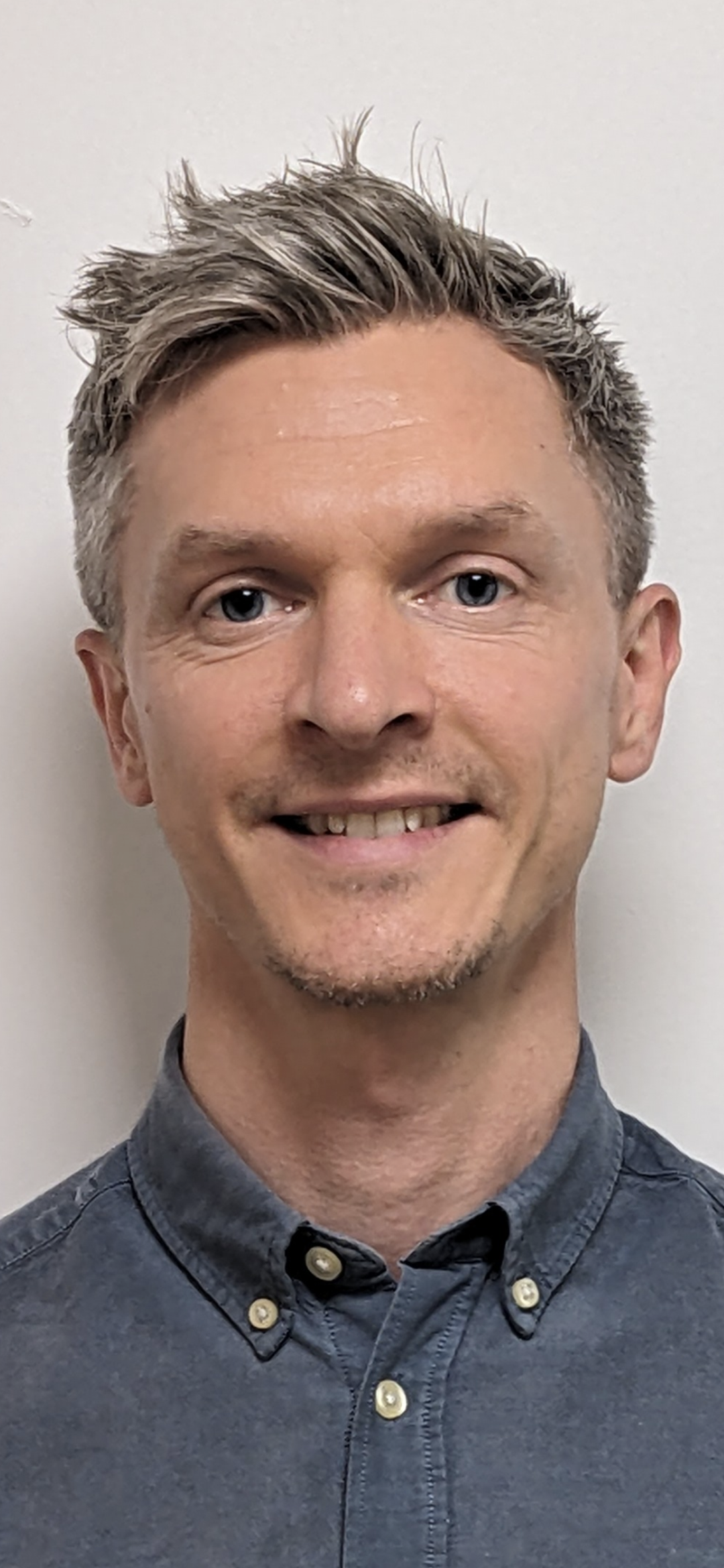 Tom smiling at the camera.