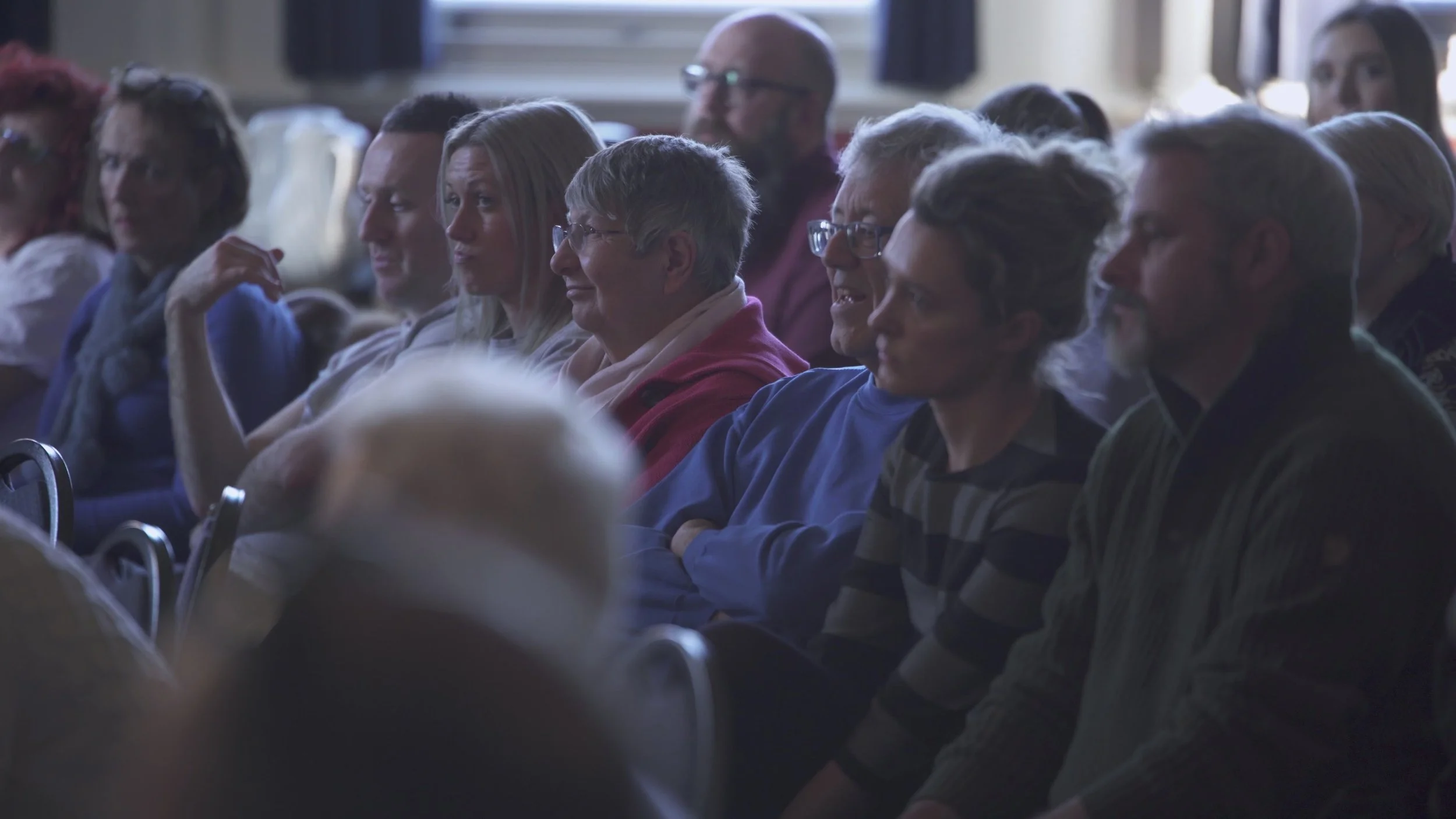 A group of people sat watching an event.