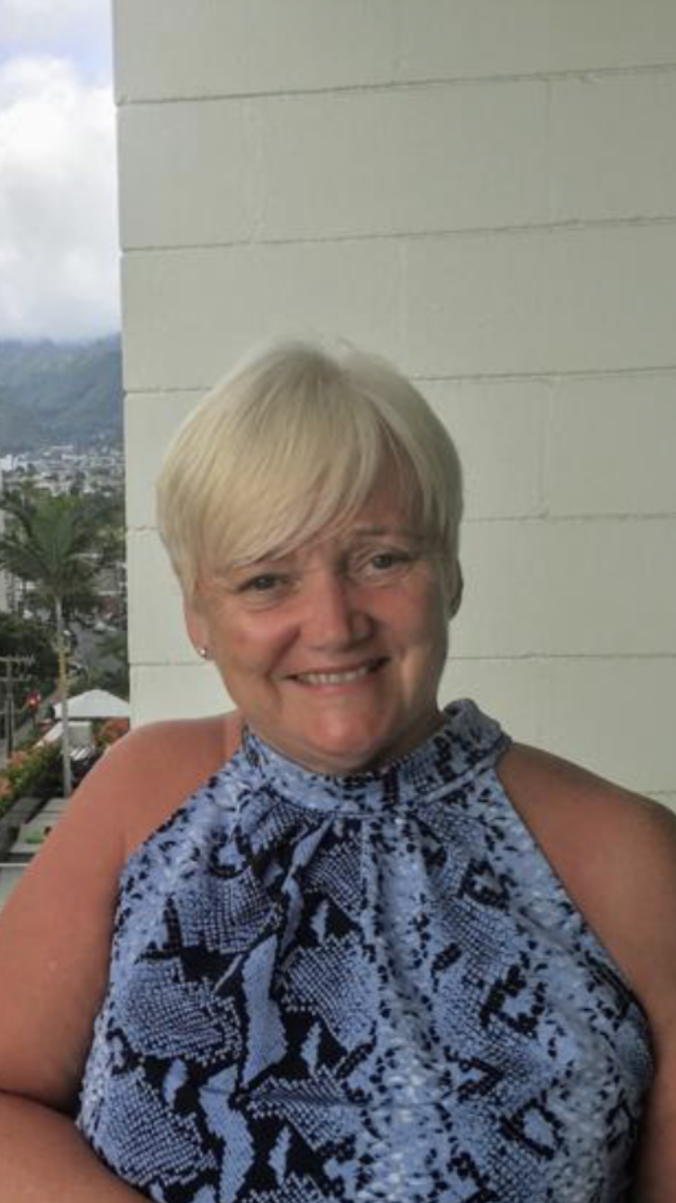 Linda on holiday, smiling at the camera.