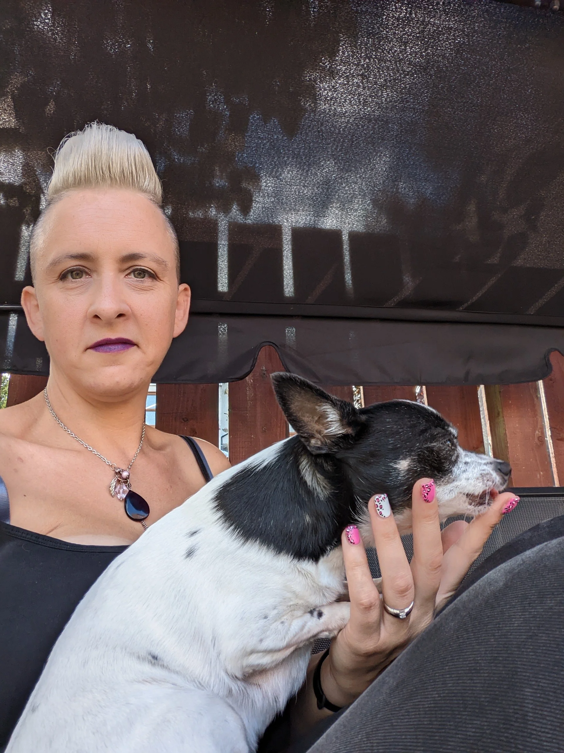 Petra holding her dog and smiling at the camera.