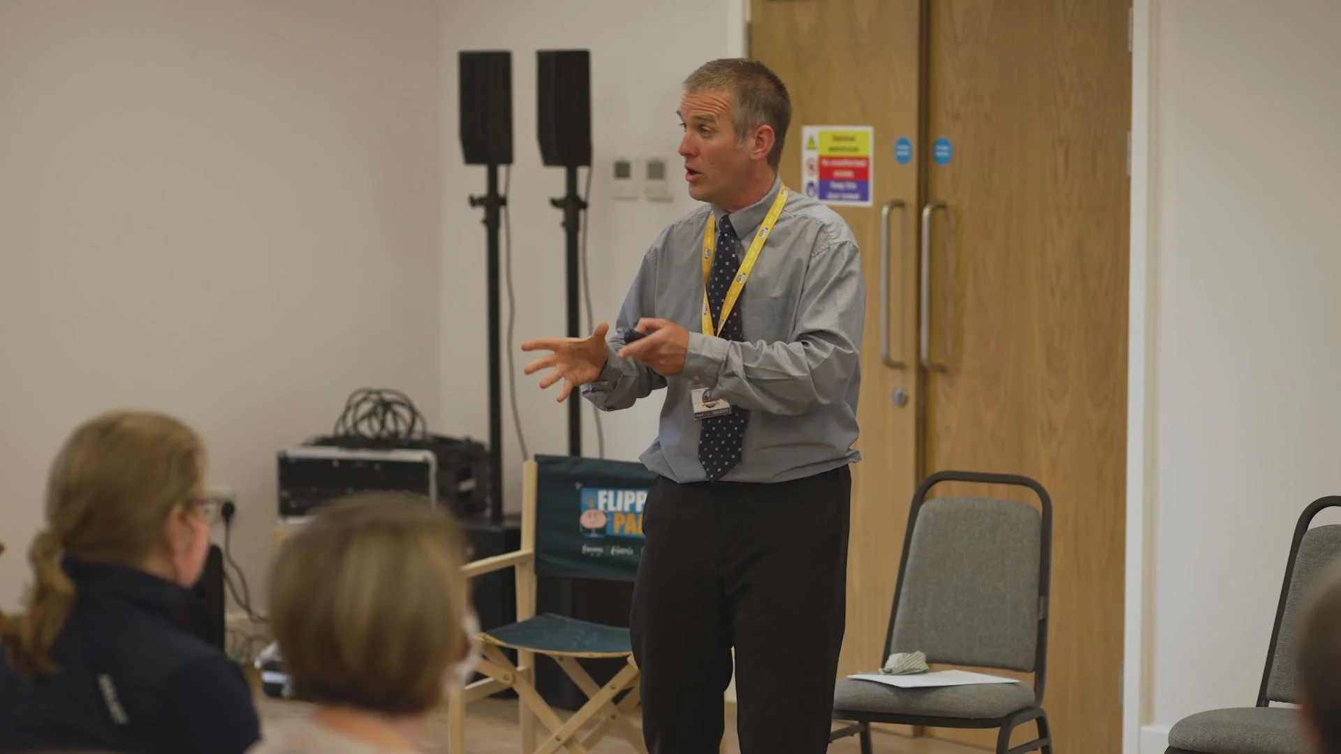 Speaker Cormac speaking in front of a crowd.