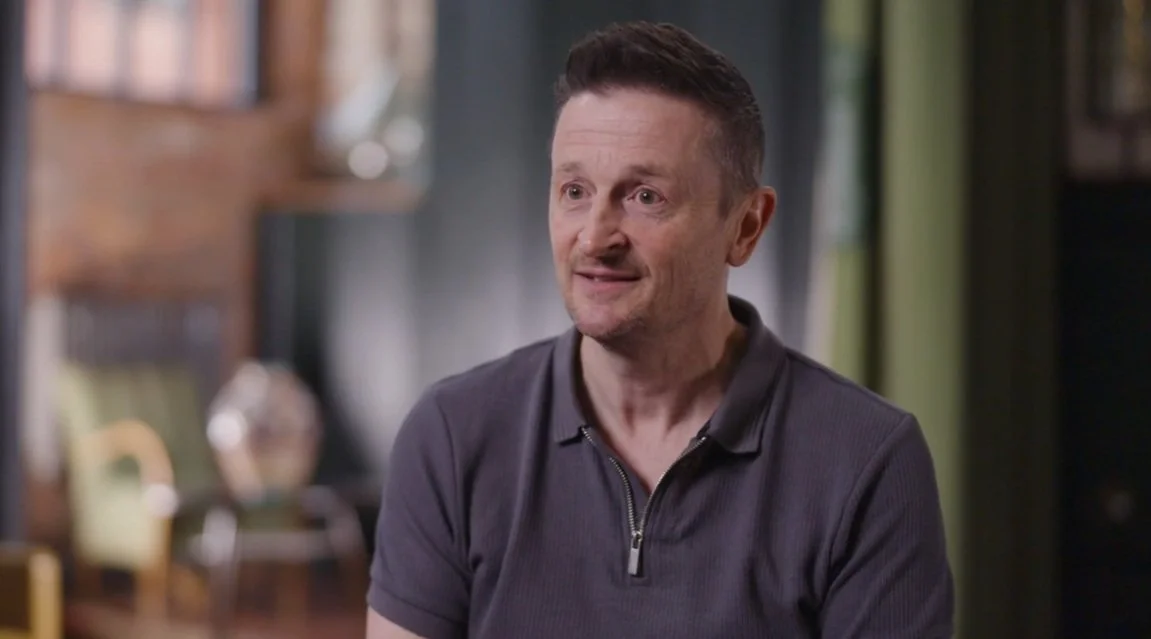 Lee smiling at the camera.