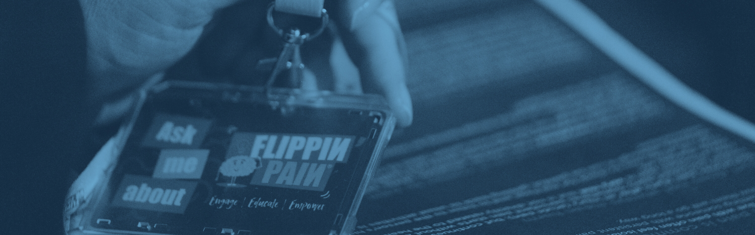 Someone holding a Flippin' Pain lanyard.