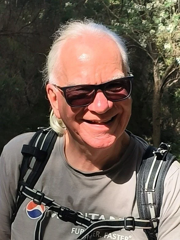 A man in sunglasses smiling.