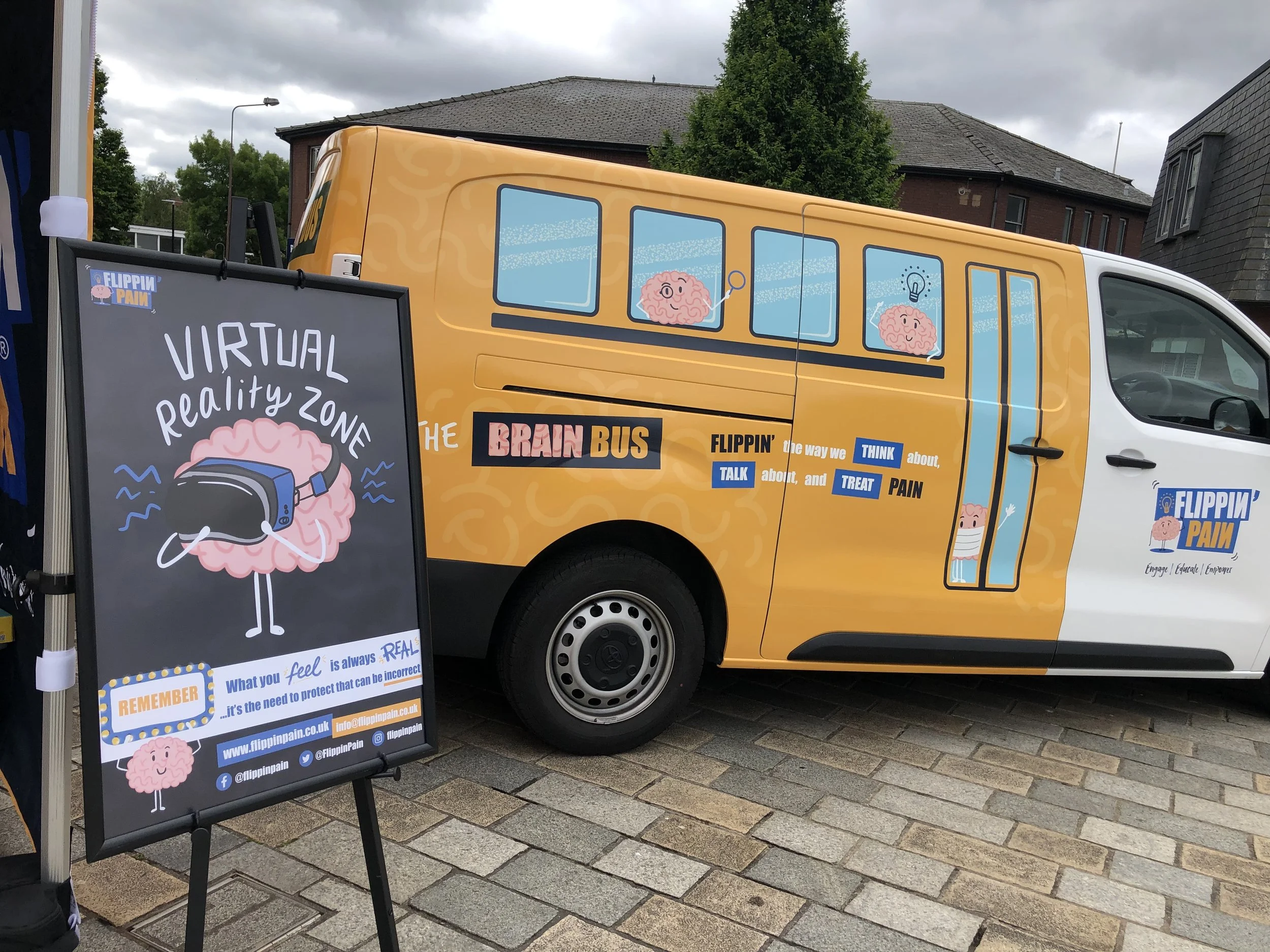 The 'Brain Bus': a van with Flippin' Pain and a sign next to it, saying 'Virtual Reality Zone'.